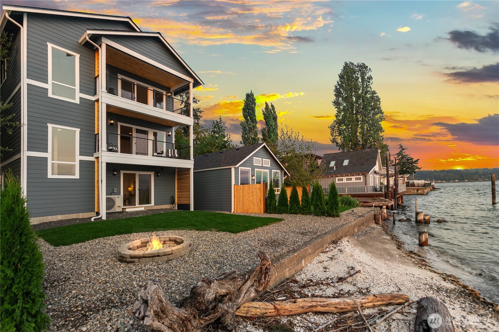 This brand new 2025 waterfront home on coveted Shore Dr in Manette evokes feelings of relaxation and peaceful living. Every view out of the windows feels like floating on the water—watch ferries, boats, wildlife, and stunning west-facing sunsets. No-bank waterfront with tideland ownership offers easy, low-maintenance living just minutes by foot or bike to the Bremerton & Fast Ferry. Inside, vaulted ceilings, Milgard windows, gas fireplace, two-tone cabinets, bar with beverage fridge, and high-end Samsung appliances shine. 3 bed, 3.5 bath with en suites in every room, including a vaulted primary with balcony, spa-like bath & walk-in closet. Extras: Daikin mini-splits, EV charger, and tankless water heater.