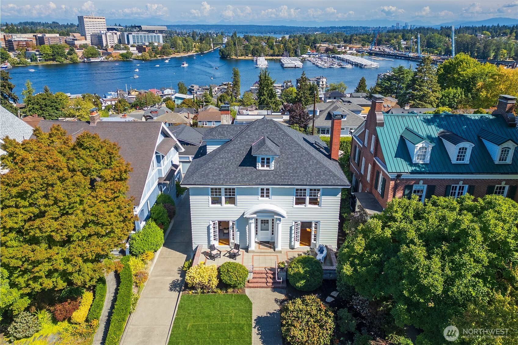 First time on the market in almost 7 decades! Graciously positioned in coveted Roanoke Park, this stately ~4,000 sq. ft. residence offers a combination of scale, character, and breathtaking views. From its generous proportions and timeless architectural details to its sweeping vistas of the Montlake Cut, Montlake Bridge, Husky Stadium, and Cascade Mountains, this is a home of undeniable presence and distinction.Rich with original character, the top two levels feature gracious living spaces, built-ins, original hardwoods and fir floors, and French doors opening to exterior terraces that capture the remarkable surroundings. Four bedrooms plus an eastern-facing sunroom and two bathrooms occupy the upper level, including a private primary suite with exceptional views.The home's substantial footprint provides an exciting canvas for the next chapter. An unfinished, walk-up attic offers potential for future expansion while the main-floor office and flexible daylight lower-level space provide options for a home office, fitness area, guest accommodations, or other lifestyle needs. Fresh interior and exterior paint and a newer roof provide a strong foundation for thoughtful updates and personalization.Even the garage enjoys a view—an uncommon detail that speaks to the serene setting. With convenient access to SR 520 and I-5, this remarkable Roanoke Park property presents a rare opportunity to restore, refine, and reimagine a grand home in one of Seattle's most coveted locations