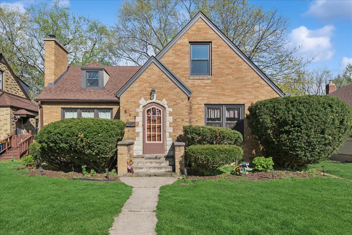 Discover timeless elegance in this charming 1942 Tudor home located in the heart of Elgin. This charming residence seamlessly blends vintage appeal with modern comforts, featuring a classic brick exterior. Inside, find two main floor bedrooms complemented by a full bath, including an upstairs private master en suite with new carpet, cozy alcove and second full bath, plenty of storage and closet space too! The unfinished basement with wood burning fireplace offers laundry area, potential second family room or office space. Protect your vehicles and add extra storage with an oversized detached two-car garage. Recent updates include a newer roof, all-new windows, and newer chimney, ensuring worry-free living. Enjoy year-round comfort with a newer HVAC system installed in 2021. Bask in natural light in the inviting sun porch, and gather around the cozy gas fireplace in the living area. Hardwood flooring throughout the main level. The property is surrounded by professional landscaping, mature trees and pretty perennials, enhancing its curb appeal. Located just a couple of blocks from the Elgin National Watch Historic District on the East side, this home offers a rich historical setting. Take advantage of low property taxes, providing excellent value. Elgin, known as the 'City in the Suburbs,' provides a walk and bike-friendly community along the scenic Fox River and trails. Discover dining, shopping, recreation, and entertainment, within 15 min proximity to Barrington Arboretum, Downtown St. Charles, numerous churches, parks, museums, the Pace bus route, and Metra. Experience the perfect fusion of tradition and contemporary living in this fantastic Tudor home!
