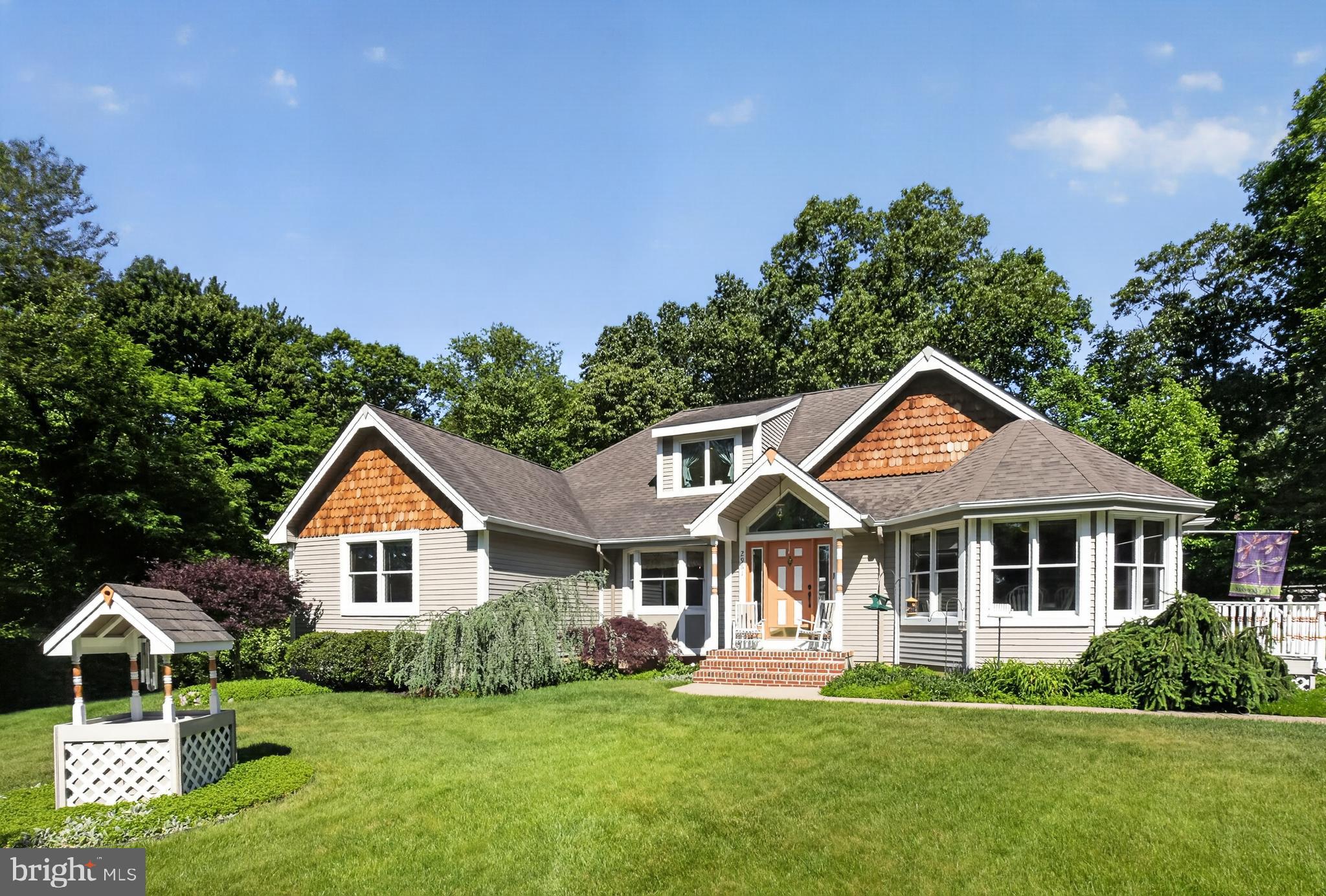 Tucked away on a stunning 1.43-acre flag lot, this custom-built contemporary Cape Cod is a true hidden gem — your own little Shangri-la surrounded by woods, gorgeous landscaping, ornamental trees, and peaceful nature views. A partially paved driveway creates a grand entrance while offering parking for multiple vehicles.  Inside, sunlight pours through abundant Anderson windows and doors, highlighting the beautiful hardwood flooring and spacious open layout. The showstopping family room features vaulted ceilings, hardwood floors, dual ceiling fans, deck access, and a ceiling to floor brick fireplace with Avalon wood stove capable of heating the home while keeping utility costs low. The adjoining living room features a stunning birch accent wall and additional access to the deck, creating the perfect flow for indoor and outdoor living. The spacious kitchen offers new stainless-steel appliances, pantry closet, peninsula seating, and a bright dining area with bow windows. The formal dining room with bay window also makes a perfect office or flex space. The main floor includes 3 bedrooms, including a primary suite with walk-in closet, ensuite bath, and slider access to the deck and hot tub area. A large foyer with vaulted ceilings leads to a second-floor loft and bonus room ideal for a home office, guest space, or possible 4th bedroom, plus plenty of walk-in floored storage.  The backyard retreat feels like a vacation at home with multiple decks, lighted Hot Springs hot tub, fire pit area, regulation horseshoe pits, hammock space, and serene wooded surroundings. Additional features include a finished basement game room, bilco doors to the side yard, huge unfinished basement area with endless potential, a 1.5-car insulated garage with 220 amp service and water hookup, separate carport, and quality construction details throughout the home and property.  Lovingly and meticulously maintained by the current owners for the past 30 years, this one-of-a-kind property offers a rare combination of character, comfort, and peaceful living. Homes like this do not come along often — you truly need to experience it in person to appreciate everything it has to offer.