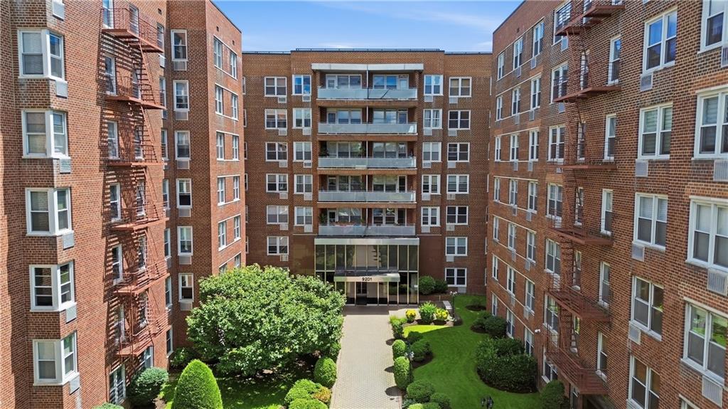 Welcome to Apartment B103 at 9201 Shore Road, a spacious and well-maintained residence featuring approximately 9-foot ceilings and a functional layout designed for comfortable living.The oversized living room is highlighted by two large windows, custom curtains and drapes, built-in wall air conditioning, and sleek sradiator covers. Just off the main living area is a flexible space ideal for a home office or formal dining area. Two large entry closets provide exceptional storage.The updated kitchen features tile flooring, stainless steel GE appliances, including a refrigerator, dishwasher, microwave, and five-burner gas stove.The full bathroom is finished with tile flooring. The south-facing secondary bedroom offers generous natural light and a large closet, while the spacious primary bedroom easily accommodates a king-size bed and features two large closets, two windows, 9-foot ceilings, and built-in wall air conditioning.Monthly maintenance is $1,337. Building amenities include a parking garage with a short waitlist.