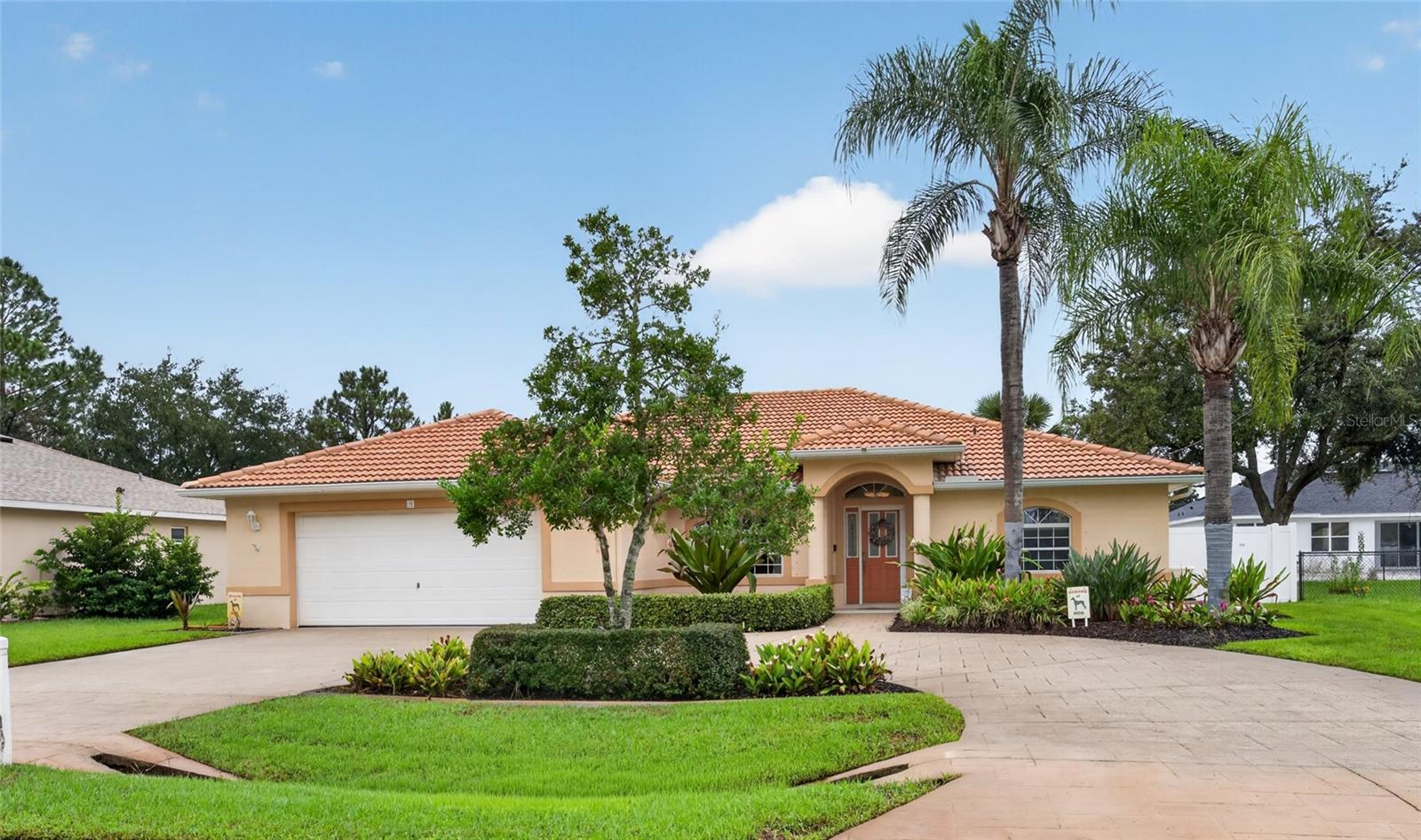 Not your typical Palm Coast home. Custom built by Amaral and thoughtfully remodeled, this beautifully maintained residence reflects quality craftsmanship, attention to detail, and years of thoughtful improvements.Located in Indian Trails, this 3-bedroom, 2-bath home offers a split floor plan, vaulted ceilings, an oversized two-car garage, and inviting indoor and outdoor living spaces. The remodeled kitchen features custom cabinetry, granite countertops with a full-height backsplash, updated appliances, and under-cabinet lighting. Both bathrooms have been beautifully renovated, complemented by updated lighting and custom closet organizers throughout.Outdoor living is equally inviting. An expansive screened lanai with porcelain tile flooring, retractable sunshades, and an entertainment system extends the living space, while two composite decks, an 18-foot retractable awning, privacy fencing, and landscape lighting create additional places to gather or unwind.Beyond its beautiful presentation, this home offers an impressive collection of practical improvements, including a whole-house Generac generator installed in 2023, AstroGuard hurricane fabric protection, a concrete tile roof, high-efficiency HVAC system (2019), water heater (10/2026), water softener, and well-fed irrigation.Even the oversized garage has been thoughtfully designed with built-in cabinetry, workspace, an insulated garage door, and an attic lift for additional storage.Conveniently located near shopping, dining, golf, and Palm Coast's Atlantic beaches, 110 Burroughs Drive offers something increasingly appreciated: an established home with character, meaningful improvements, and exceptional attention to detail.