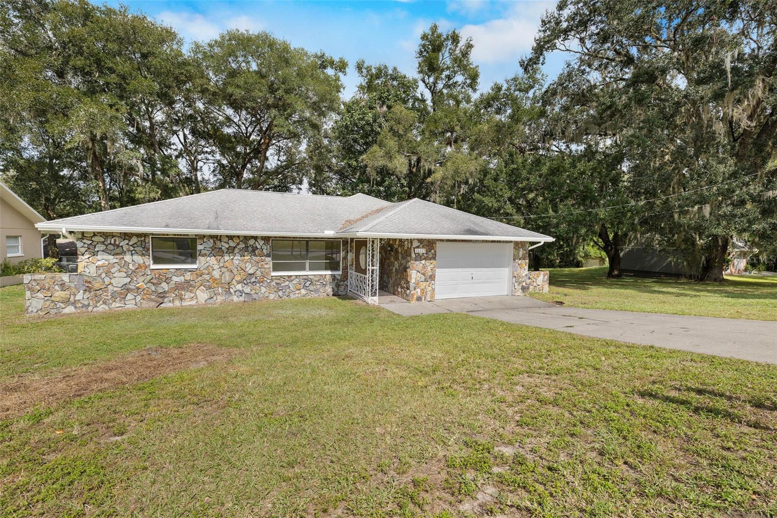 Welcome to this move-in-ready 3 bedroom, 2 bath home with a 2-car garage, situated on a spacious 1/3-acre lot. This charming block home has been thoughtfully updated with a brand new AC (2025), fresh interior and exterior paint, completely renovated bathrooms, and a stunning kitchen featuring new white shaker cabinets, quartz countertops, and modern finishes.

Inside, you'll love the split floor plan offering privacy, new vinyl plank flooring, and new carpet in all bedrooms. The primary suite boasts a large walk-in closet and a private ensuite bathroom with a new vanity and a shower/tub combo.

Step outside to your screened-in rear patio—perfect for morning coffee or evening relaxation. The oversized, fenced backyard is shaded by mature oak trees and offers plenty of space for entertaining, gardening, or even a future pool.

Centrally located between I-75 and downtown Brooksville, with quick access to Tampa and local dining spots—this home combines comfort, convenience, and value. Don't miss out!
