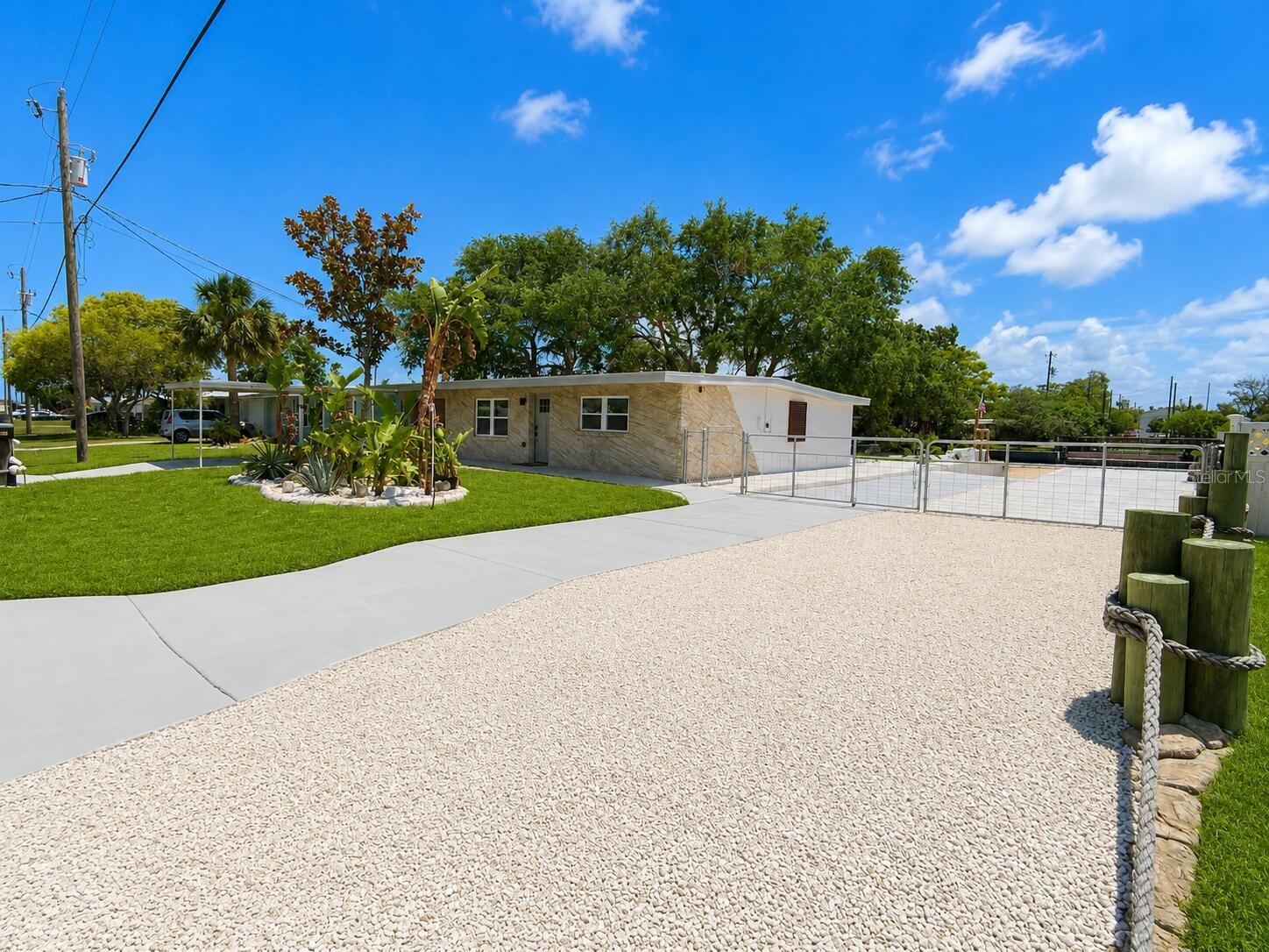 Virtually Staged. One-of-a-kind waterfront retreat with private boat launch and direct Gulf access. Home or rental investment, this beautifully renovated property blends modern coastal design with custom artisan finishes rarely found in the area. Inside, you'll find an open-concept layout, sculpted architectural details, recessed lighting, a stylish kitchen with breakfast bar, and a spa-inspired bathroom that creates a true resort atmosphere. Wheelchair friendly. Large windows and French doors bring in natural light and connect the interior seamlessly to the waterfront outdoor living spaces.Waterfront Canal Retreat - Move-In ReadyBeautifully updated waterfront home on a wide canal with direct access to the Gulf. This coastal retreat features a bright open layout, extensive concrete and shell landscaping, mature shade trees, and multiple outdoor gathering areas designed for Florida living.Amazing and fun neighborhood and neighbors.Enjoy relaxing by the water, swinging beneath the sprawling oak canopy, or entertaining on the spacious covered patios. The property has plenty of parking for vehicles, boats, trailers, and RVs, along with a large waterfront yard and private dock area.Recent improvements and thoughtful upgrades create a clean, low-maintenance property that's ready to enjoy immediately. The tropical landscaping, waterfront seating areas, hammock lounge, and unique outdoor spaces make this home ideal as a primary residence or rental investment.Exterior Highlights:Personal boat launch Waterfront canal location with Gulf accessPrivate dock with stairs for a ramp that adapts to the tideOutdoor shower SeawallSpacious covered patiosRare lot and a halfLarge driveway with ample RV, boat and trailer parkingMature oak trees providing exceptional shadeTropical landscaping and outdoor living areasLow-maintenance stone and concrete groundsMove-in ready conditionFresh coat cooling roof coating on 10 year old great condition asphalt roofNo HOAExperience the best of Florida waterfront living with room to relax, entertain, boat, fish, and enjoy spectacular sunsets right from your backyard.Interior Features:Open-concept floor plan designed for entertainingCustom coastal-inspired durable flood resistant finishes throughoutUnique hand-crafted textured walls and architectural detailsUpdated kitchen with breakfast bar seatingNew stainless steel appliancesRecessed LED lighting throughoutEnergy efficient reliable Mitsubishi mini split AC system.Spacious living area with abundant natural lightDesigner bathroom featuring custom sculpted vanity, integrated shelving, and modern fixturesWaterfront views from multiple living spacesTurn-key condition with a distinctive resort-style feelTo much to list