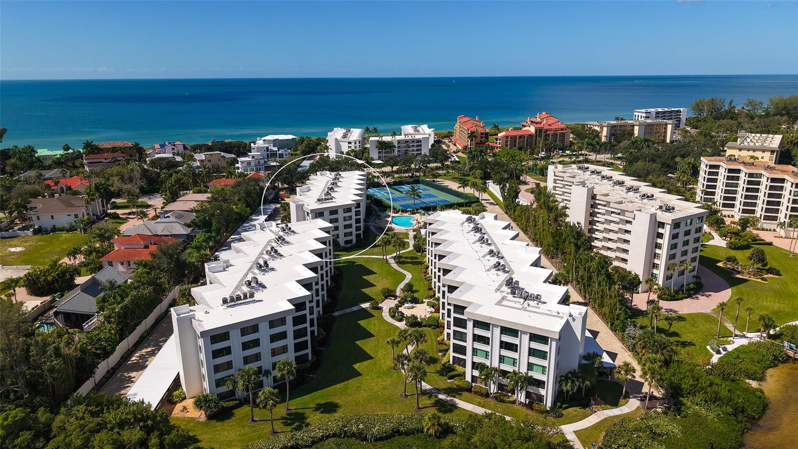 Welcome home to your tropical retreat at Island Reef on south Siesta Key! Island Reef is a Gulf to Bay resort style community. Amenities include: 2 heated pools, private beach, pickleball, tennis, clubhouse and docks. There is an active social calendar and in-house rental management as well. This beautiful penthouse unit has a wonderful pool and courtyard view. 504G is being offered Turnkey Furnished.This beachy condo has been extensively upgraded including the kitchen, both bathrooms, a laundry with full-size washer and dryer, and a raised ceiling in the dining area. The knotty pine floors and doors are reminiscent of a coastal cottage. Indirect lighting can be dimmed to suite your needs. A new AC was installed in Oct 2026 and the warranty will be transferred to the new owners.The kitchen and bathrooms have solid wood paneled cabinets, granite countertops, and subway tile bath and shower surrounds. In the kitchen the lighted cabinets allow for a beautiful display of dishes, glassware, and favorite collectibles. The living room and dining area have comfortable coastal furniture. The large dining table holds 6-8. Glass sliding doors open to a garden style lanai with slate tile flooring. Enjoy the tropical breeze and pool view while sipping your morning coffee on this wonderful lanai. Throughout the condo there are several unique antique wood chests and other furniture pieces., which are perfect for additional storage. The coastal artwork and knick-knacks are included in the purchase of this home.From the primary bedroom, you can also access the lanai through sliding glass doors. There is a large walk-in closet and an ensuite bathroom with dual sinks and large shower. The guest bedroom has a three-piece full wall shelving /desk unit. There is also a full wall built-in closet. Across the hallway is a laundry and storage room.If you are ready to make a move to paradise, please call for a private showing.  When you see 504G you will fall in love! Buy now and enjoy winter on Siesta Key!