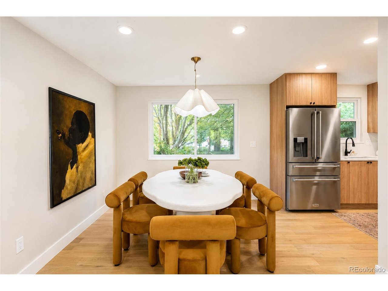 OPEN HOUSE 6/27 & 6/28 @ 11AM!  Welcome to THE ONLY ACTIVE LISTING in Ridgeview Hills North that has been professionally renovated from top to bottom, priced under $750K.  This fully reimagined 4-bedroom, 3-bath showpiece sits on a large corner lot in a quiet, desirable neighborhood surrounded by amazing schools and an awesome community. Every inch of this home has been redesigned, blending custom craftsmanship and high-end finishes you won't find anywhere else at this price point.  Step inside to engineered hardwood floors that flow through the main level, while cozy luxury carpet adds warmth throughout the upstairs and basement.  At the heart of the home, a standout chef's kitchen awaits, featuring custom cabinetry and Thor stainless steel appliances, including a 5-burner gas range set beneath a striking arched stove cove. The light-filled family room boasts vaulted ceilings, stunning natural wood beams and a brick, wood-burning fireplace, with oversized sliding glass doors that connect you to the outdoors.  The spa-inspired primary bath is a retreat, featuring a massive walk-in shower, high-end tile, two separate vanities and a freestanding soaking tub framed by custom lighting. Downstairs, the finished basement adds incredible flexibility, ready to become a game room, entertainment lounge, home gym or additional bedroom. Outside, enjoy a covered front porch, covered back patio and expansive wood deck overlooking the fully fenced, professionally landscaped backyard perfect for entertaining or letting kids and pets play. The premier corner lot sits perched on a hill, offering extra space and privacy.  Central A/C and a powerful whole-house attic fan keep the home cool and comfortable during Denver's hottest summer days. Unbeatable location near top-rated Lois Lenski Elementary & Newton Middle Schools, the Highline Canal Trail and Little Dry Creek Park.  Enjoy local favorites like OneFold, Snooze, and Halo Rooftop Bar!