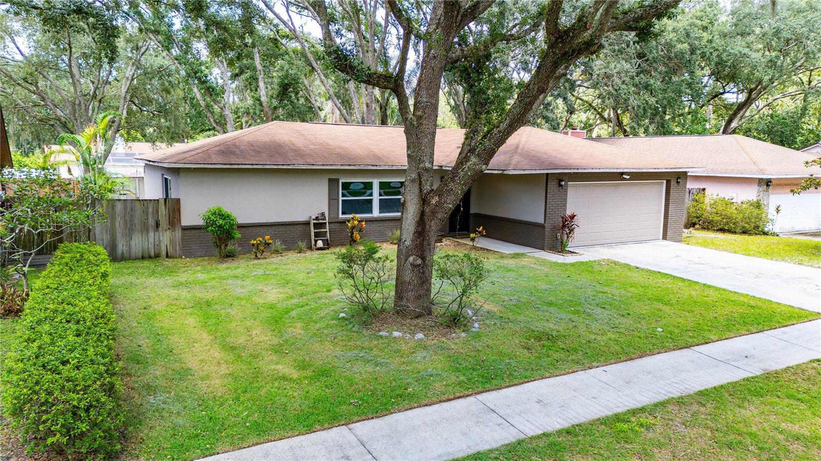 Nestled beneath the canopy of majestic oak trees in the established community of Silver Forrest, this beautifully renovated home offers the perfect blend of timeless charm and modern updates. Ideally located near USF, scenic nature preserves, shopping, dining, and major commuter routes, you'll enjoy both convenience and the peaceful setting this sought-after neighborhood provides.Inside, the thoughtfully designed split-bedroom floor plan has been completely transformed with stylish luxury vinyl plank flooring throughout the main living areas, an updated kitchen featuring granite countertops and new cabinetry, and beautifully renovated bathrooms with designer tile showers, granite vanities, and new cabinetry. The spacious primary suite offers a private retreat with a stunning ensuite bath complete with a double vanity and elegant finishes.The living spaces flow effortlessly outdoors through two sliding glass doors leading to an impressive 28' x 19' screened lanai—perfect for entertaining, relaxing with your morning coffee, or enjoying Florida's beautiful weather year-round. Additional upgrades include energy-efficient windows installed in 2019, while the fully fenced backyard features newer wood fencing and a cozy fire pit, creating the perfect setting for evenings with family and friends.Move-in ready and beautifully updated, this exceptional home offers the lifestyle you've been searching for in one of Lutz's most established and picturesque communities.