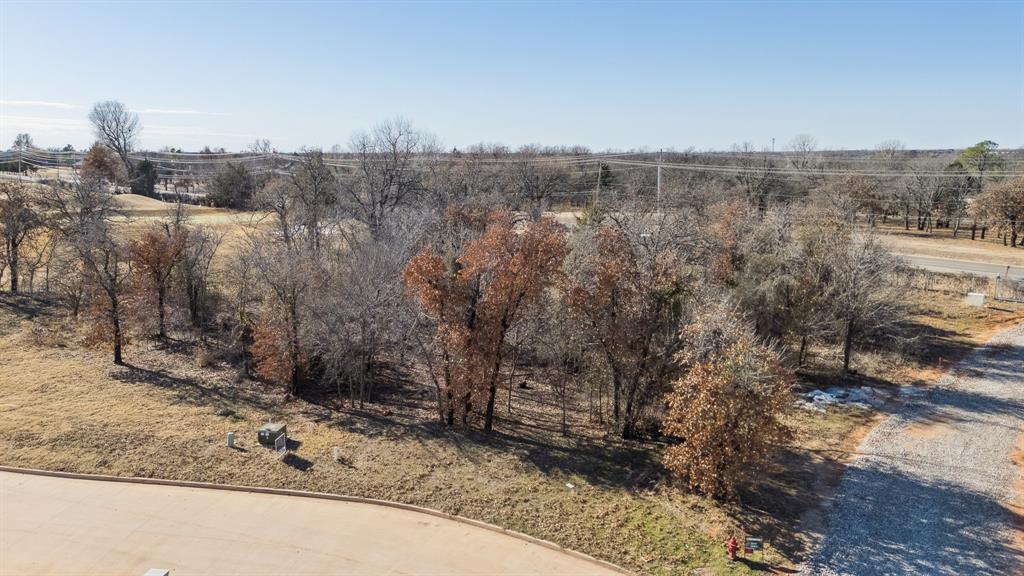 Rare opportunity to build your dream home on a premier golf course–front lot in the prestigious Oak Tree community. This property sits directly on the course, offering beautiful views and a highly desirable setting. Seller has home specifications available, providing a great starting point for new construction. Enjoy gated community living, mature surroundings, and convenient access to country club amenities, shopping, dining, and Edmond schools.