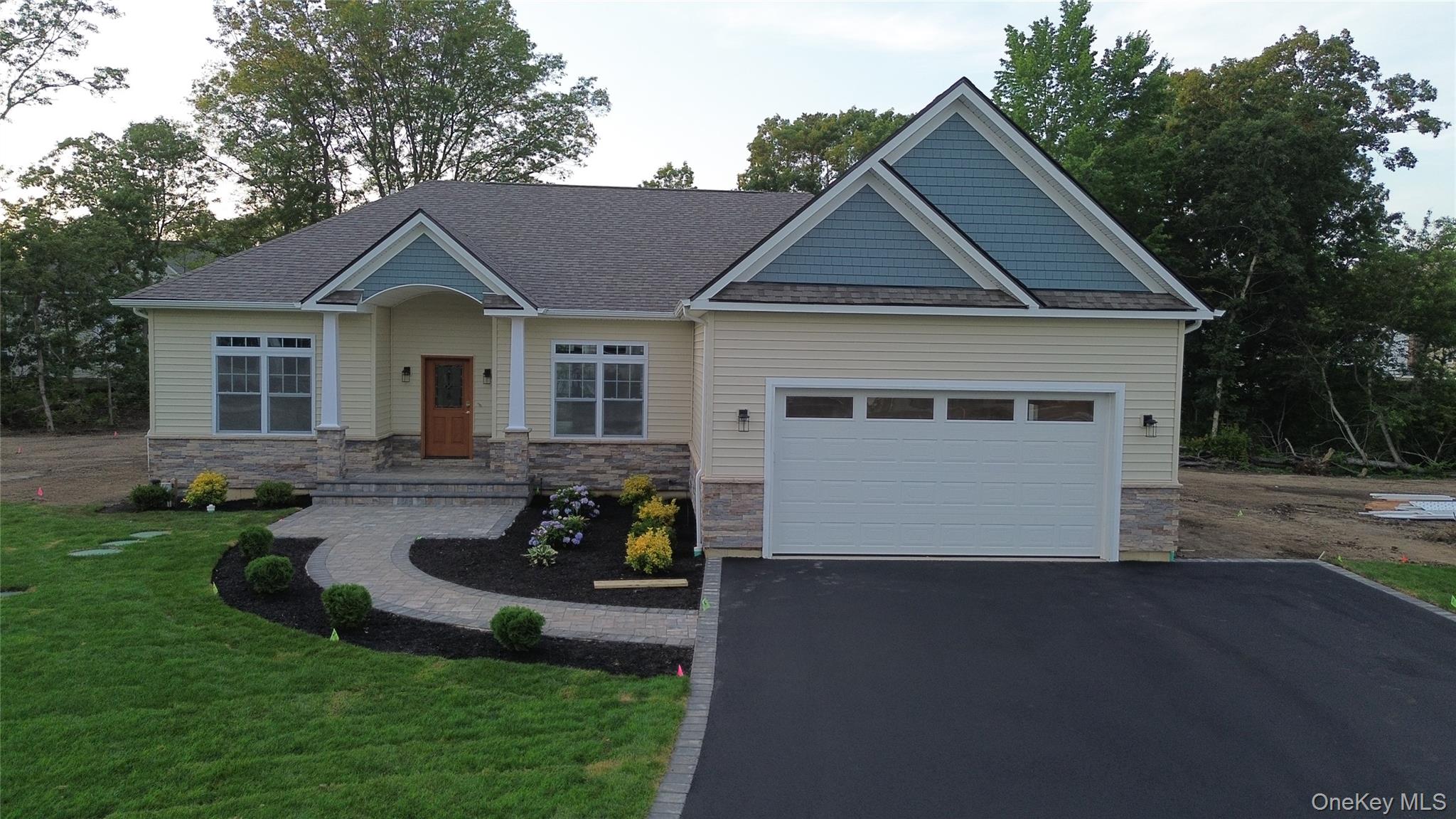 Premier new construction opportunity in Port Jefferson Station featuring the Hampton Ranch model by Terra Construction Group. This thoughtfully designed single-level home offers approximately 2,150 sq ft of living space with 3 bedrooms and 2 bathrooms, set on an oversized lot of approximately 2.50 acres within a premier new construction development. The open floor plan features 9-foot ceilings, hardwood flooring in the main living areas, recessed lighting, and a spacious living and dining layout ideal for everyday living and entertaining. The gourmet kitchen includes custom shaker-style cabinetry, quartz countertops, stainless steel appliances, and quality finishes throughout. The primary suite offers a private retreat with en-suite bath, while additional bedrooms provide flexibility for guests or home office use. Additional highlights include a full unfinished basement, attached two-car garage, fireplace in the main living area, energy-efficient windows, two-zone heating and central air, and a private on-site I/A OWTS sanitary system. Model pricing, specifications, square footage, and finishes are subject to change.