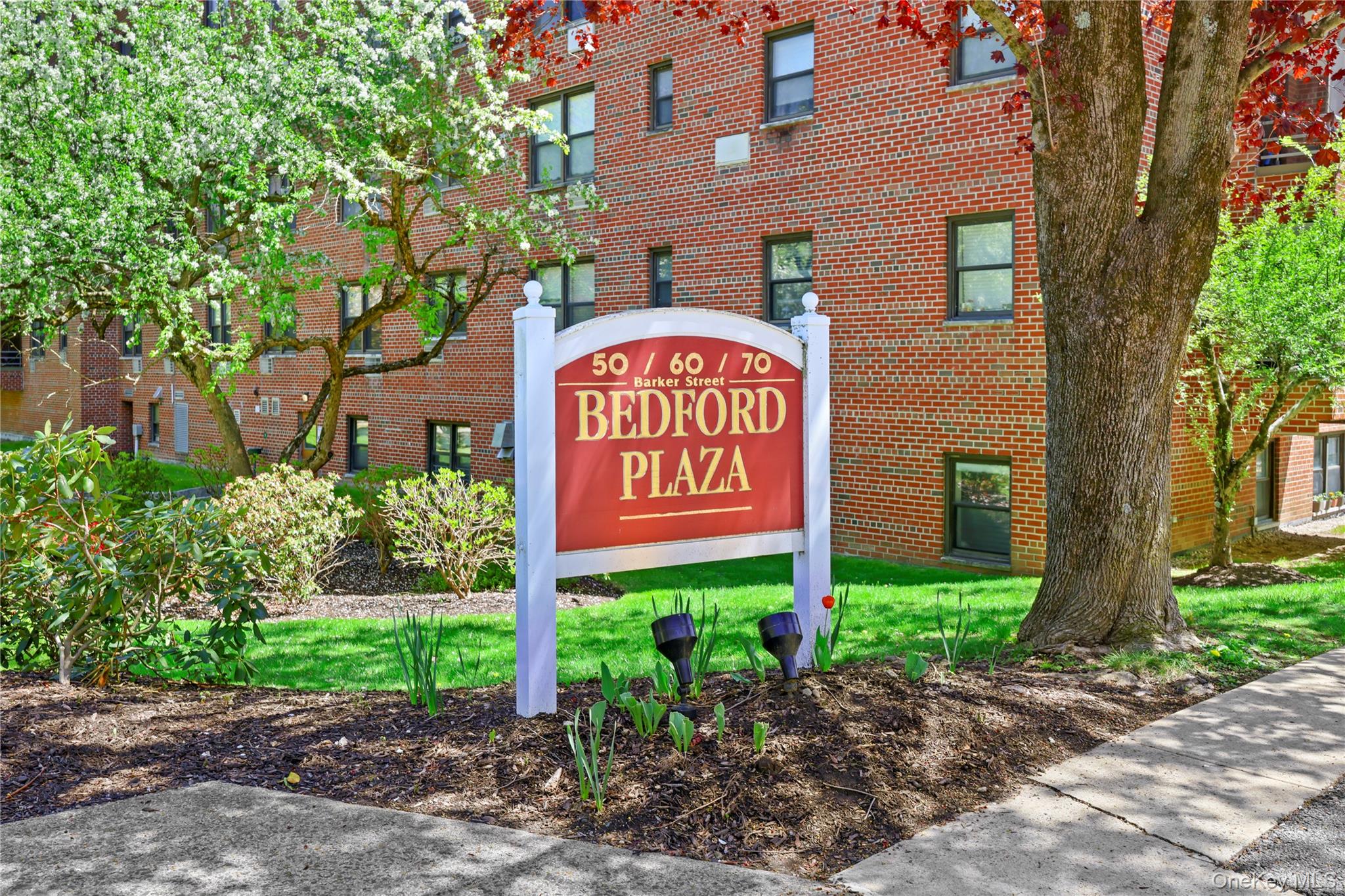 Experience sophisticated mid-rise living at 70 Barker Street. This classic brick residence is nestled within serene, professionally landscaped grounds and offers a refined lifestyle focused on relaxation and recreation. The sun-drenched interior features a spacious layout with original parquet hardwood flooring throughout the expansive living and dining areas. You will appreciate the windowed galley kitchen equipped with extensive granite countertops, warm wood cabinetry, and a full suite of appliances. The bedrooms serve as airy retreats with large windows providing tranquil views of the surrounding mature trees. Beyond the residence, community amenities are second to none, featuring a sparkling oversized swimming pool, a modern playground, and an expansive paving-stone patio with picnic stations perfect for hosting. With a blend of classic charm and modern convenience, including secure entry and on-site parking, this property is a true lifestyle destination. Schedule your private showing today to experience the best of Bedford Plaza.