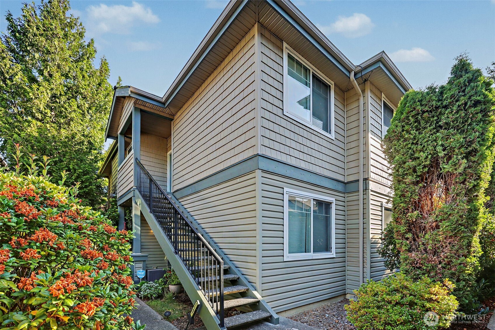 Spectacular is the only way to describe this gorgeous end-unit home in the highly sought-after, gated Steeple Chase Hill community! Offering added privacy, controlled access, and a wonderful sense of community, this is a place you’ll be proud to call home.  Light, bright, and beautifully inviting, this spacious 2-bedroom, 2-bath, 1,153 sq. ft. home is filled with natural light and offers the perfect blend of comfort, style, and convenience. Soaring 9-foot ceilings create an open and airy feel, while the cozy gas fireplace makes the generous living room the perfect place to relax or entertain.  The updated kitchen is sure to impress with abundant cabinetry, and a convenient breakfast bar. Tucked privately at the back of the home, the spacious primary suite is a true retreat featuring an ensuite bath with dual sinks and a large walk-in closet. The generously sized second bedroom and additional full bath provide wonderful flexibility for guests or a home office.  Step outside and enjoy your private covered deck year-round—perfect for morning coffee, evening relaxation, or entertaining. A private 1-car garage adds even more convenience and storage.  The community amenities are fantastic! Enjoy a clubhouse with a large gathering space, kitchen, game room, and gym—all within this desirable gated community. Incredible location  End unit, gated community, beautiful natural light, fantastic amenities, private garage, and an unbeatable location—this is the one you’ve been waiting for.