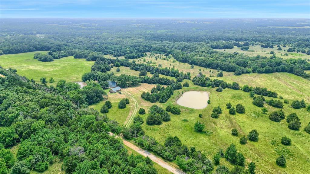 Discover the perfect blend of privacy, recreation, and opportunity located minutes from Lake Texoma! This beautiful property offers wide-open Texas land and a peaceful setting ideal for those looking to escape the city, build a private retreat, or invest in acreage with future potential. Outdoor enthusiasts will appreciate the excellent hunting and fishing opportunities, making this an ideal property for a weekend getaway, recreational ranch, or full-time country residence. With plenty of room to roam and enjoy the outdoors. Adding to its investment appeal, the land can be subdivided, providing flexibility for future development, multiple homesites, or the opportunity to sell individual parcels. Nestled among a variety of mature trees and two ponds, the property features a charming A-frame home. The property also includes a two-car covered carport and an attached workshop, offering convenient covered parking along with valuable space for tools, equipment, hobbies, or outdoor gear. Whether you're searching for a hunting and fishing property, recreational land, a private homesite, or an investment opportunity, 263 Rio Roxo Road offers versatility and the freedom to make it your own.