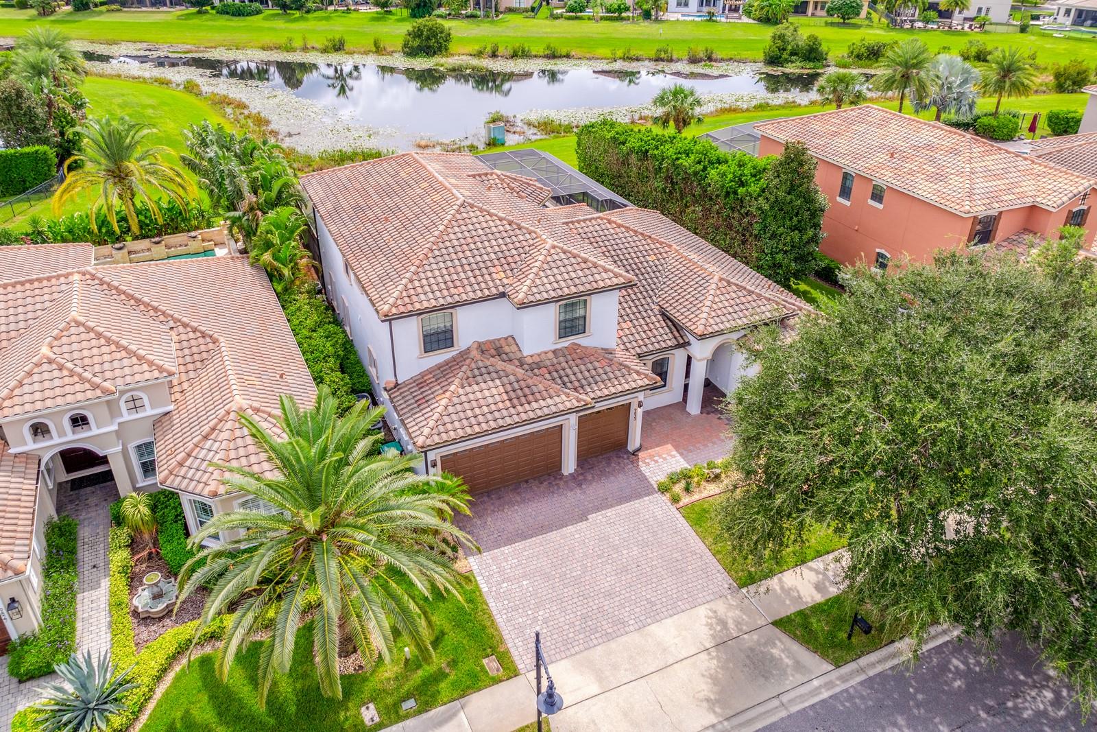 Ask about a lender provided rate buy-down credit on this home! ****Welcome to Eagle Creek, one of Lake Nona’s premier GUARD GATED ~ GOLF COMMUNITIES, where LUXURY LIVING meets RESORT STYLE AMENITIES! This executive home offers over 4,000 square feet of living space, a versatile 6-bedroom, 5-bathroom floor plan, and a backyard retreat with a PRIVATE POOL, RELAXING SPA and WATER VIEWS. Step inside to a bright, OPEN LAYOUT with elevated ENGINEERED HARDWOOD FLOORS in the main living areas and a seamless flow between formal and casual spaces. The chef’s dream kitchen is a true centerpiece, featuring rich solid wood cabinetry, stainless steel appliances, abundant counter space, complementary backsplash, and endless storage. The adjoining family room and light filled breakfast nook overlook the pool and pond, creating the ultimate INDOOR/OUTDOOR LIVING experience. The first floor delivers a spacious PRIMARY SUITE with a decorative tray ceiling, DUAL WALK-IN CLOSETS, and a spa-like bath – plus direct lanai access for morning coffee or evening relaxation. A guest bedroom and full guest bath is also conveniently located downstairs. Upstairs, you will find a spacious LOFT with a fun accent wall, two en-suite bedrooms, and two additional bedrooms that share a full bath – ideal for family, guests, or multi-generational living. Outside, enjoy your private oasis complete with a sparkling POOL featuring a SUNSHELF and WATERFALL, a SPA for unwinding, and tranquil POND VIEWS. With a TILE ROOF, 3-car garage, crown molding, French doors, and designer accents throughout, this home offers both timeless elegance and all the comforts of a modern home. ****Recent updates include a NEWER A/C (2020) and UPDATED APPLIANCES.**** And with NO CDD, this home is as practical as it is beautiful! Living in Eagle Creek means access to championship golf, a clubhouse, fitness center, tennis courts, playgrounds, scenic walking trails, and multiple pools – all within a 24-hour guard-gated community. Just minutes from Lake Nona, Medical City, Orlando International Airport, TOP-RATED SCHOOLS, shopping, dining, and major highways, as well as parks, lakes and recreation, this home is the best of both worlds – luxury living in the heart of everything Lake Nona has to offer. Call today to schedule a tour and let us say WELCOME HOME!