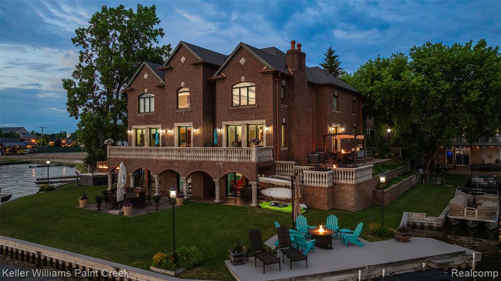 The Dragon House at 328 S Broadway is the largest and most commanding luxury lakefront residence on Lake Orion, offering a rare opportunity for true multigenerational living. Spanning over 12000 square feet, this one of a kind estate was designed to accommodate 1 to 4 households under one roof while maintaining privacy, flexibility, and seamless lakefront living. The home features 7 plus bedrooms, 8 bathrooms, 4 full kitchens, 2 entertainment spaces, 2 wet bars, and 6 beautiful fireplaces throughout the entire home, making it ideal for extended families, in law suites, or shared luxury living arrangements. Built in 2015 with exceptional quality, the property showcases ICF block construction, steel bar joists, and concrete floors for superior strength, energy efficiency, and sound insulation. Enjoy rare 270 degree panoramic lake views and a true resort style experience with an indoor saltwater pool, adjacent hot tub, and indoor sauna located next to the pool, along with an outdoor custom jacuzzi perfectly positioned for sunset views. A full wraparound deck with built in gas grills and outdoor fireplaces creates seamless indoor outdoor entertaining. Additional features include four curved staircases, 8 foot mahogany entry doors, a whole house generator, 5 furnaces, 5 AC units, and 2 tankless water heaters for comfort and efficiency throughout. Offered at 4900000, this iconic Lake Orion estate delivers unmatched scale, design, and versatility. Prices are rising on the lake, schedule your private showing today.