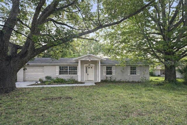 Welcome to 11836 Orange Street, located in the beautiful community of Rosewood in San Antonio, Florida with NO HOA. This well-loved home has had only one owner and offers solid construction, wonderful bones, and endless potential for someone ready to bring their vision to life. Situated on one-third of an acre, the property provides space, privacy, and room to grow.Inside, you’ll find a large open family room filled with natural light from oversized windows. The kitchen features an eat-at island, a spacious pantry, and a sliding glass door that leads to the screened-in porch—perfect for enjoying Florida’s weather year-round. Down the hallway are three bedrooms and two full baths, offering a functional layout for everyday living.Part of the garage has been thoughtfully converted into an in-law suite along with a large mudroom/second kitchen area, providing flexible space that can adapt to your needs—multi-generational living, hobby space, storage, or a future reconfiguration.With its sturdy construction, generous lot size, and versatile floor plan, this home presents a rare opportunity to customize and create something truly special in a charming, established neighborhood.