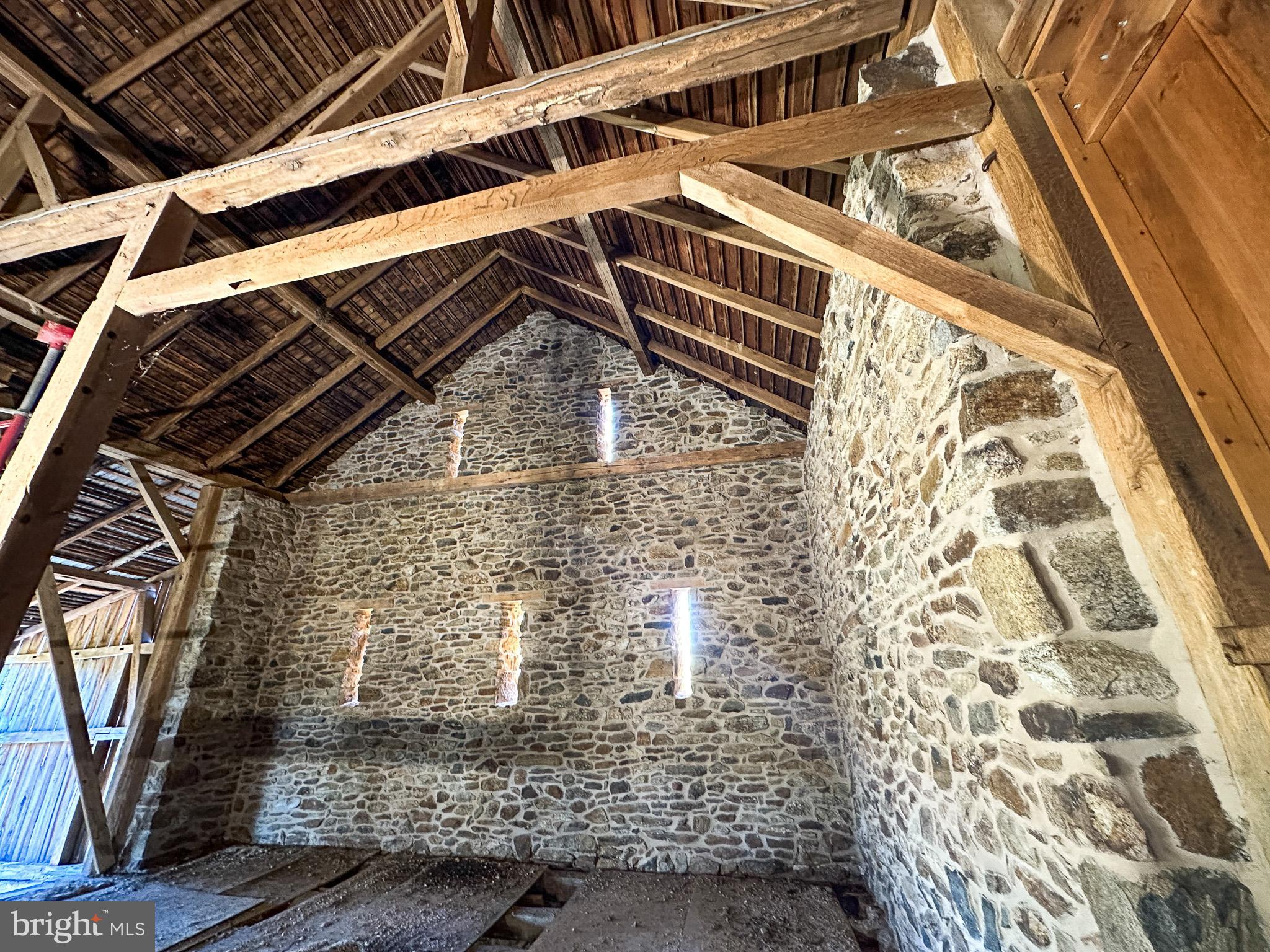 Tired of seeing the same housing options that don't capture your sense of what home should be?  Available now is the early 19th-century Stone Bank Barn on Moore Road that so many have seen.  It's an iconic piece of Chester County's rich history.   Bank barns like this can become a spectacular residence., but your imagination and desire are critical. Situated on a bucolic 1.9-acre lot with a  spring fed stream in the  Downingtown Area School District.  This hand-built "old stoney"  is complete with 2-foot-thick stone gable ends,  has all the elements of a massive timber-framed work of art layered with generations of history overlooking a lovely pond, breezy willow stream bank, and a protected location.  The barn is  so close to the hiking, biking, and boating network of Marsh Creek State Park, and you enjoy multiple entry access points.  Perc tests and septic details are known.   This is not a drill; 1this barn has amazing stone, complete with massive quoins and a gorgeous tan mortar.  Fully pointed inside and out ready for your spectacular windows and imagination.  The square footage calculation contains only the main floor and does NOT include the 68'X15' forebay section or the unfinished lower level, which walks out to daylight.  Shown by appointment only.
