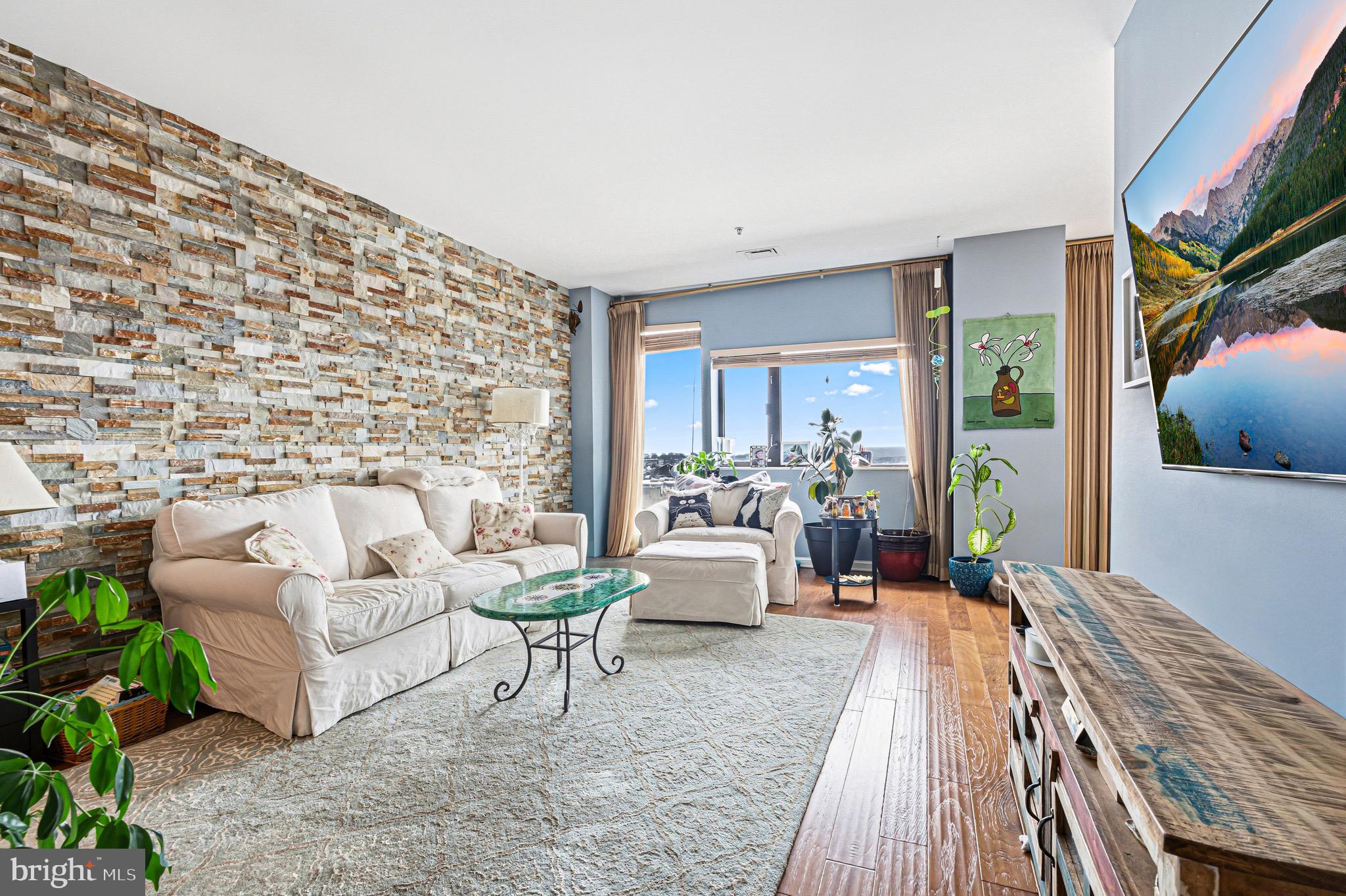 Beautifully renovated 1BR, 1.5BA condo in the Towers at Harbor Court offering sweeping city views and refined finishes throughout. The open living space features a striking stone accent wall and abundant natural light. Spacious primary suite with full bath, plus convenient half bath for guests. Includes 1 parking space and private storage unit.Enjoy luxury amenities including 24/7 front desk and door service, community room, and optional pool and fitness membership — all in a premier Inner Harbor location.