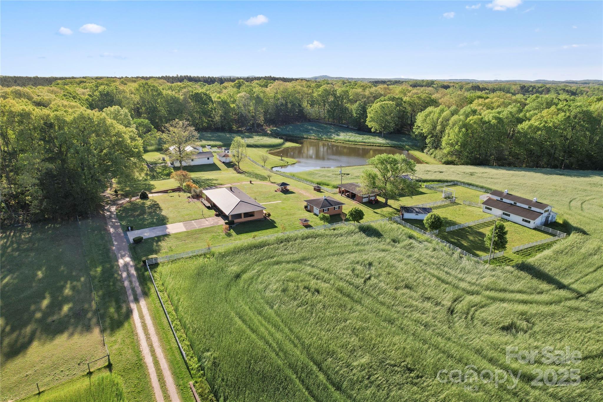 This unique property spans 29.98 acres across 5 parcels and offers a mix of residential and agricultural. Features include a 3 bedroom, 1 and a half bath main residence a barn with horse stalls, a separate building for miniature horses, an events venue, a church (needs a new roof and a lot of work inside), and a beautiful pond. A portion of the land is currently being farmed by a neighboring farmer, and the sellers request he be allowed to harvest his crops after closing. Ideal for equestrian use, events, or investment. Some of these uses will require a special use permit, due to the zoning. It's suggested buyers look into this prior to purchase for intended uses. Zoning Ordinance available upon request. Sold AS-IS with all furnishing and personal property on the property(excluding the tractor if it's still there) Air Conditioning replaced in Farmhouse July 2025.