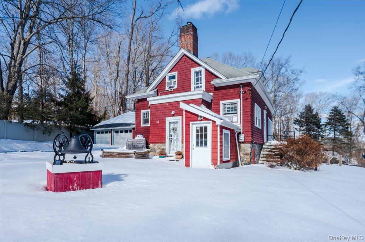 Once a classic red schoolhouse, this beautifully transformed red Cape Cod offers a truly special place to call home. Character-rich touches shine throughout, including exposed beam ceilings, knotty pine accents, wainscoting, hardwood floors, and custom built-ins. The updated kitchen features stainless steel appliances, granite countertops, and a glass tile backsplash, opening effortlessly into a bright, sun-filled dining area.An enclosed, light-filled sunroom provides an additional 352 square feet—ideal for year-round entertaining or relaxing with guests. The walk-out finished basement adds another 590 square feet and showcases the original schoolhouse chalkboards, creating a versatile space perfect for a home office, media room, or fitness area. Oil tank above ground. 2 car attached garage.This home offers the best of both worlds with scenic surroundings and convenient access to dining, shopping, Metro North, highways, schools and parks. A truly one-of-a-kind property ready for its next chapter.
