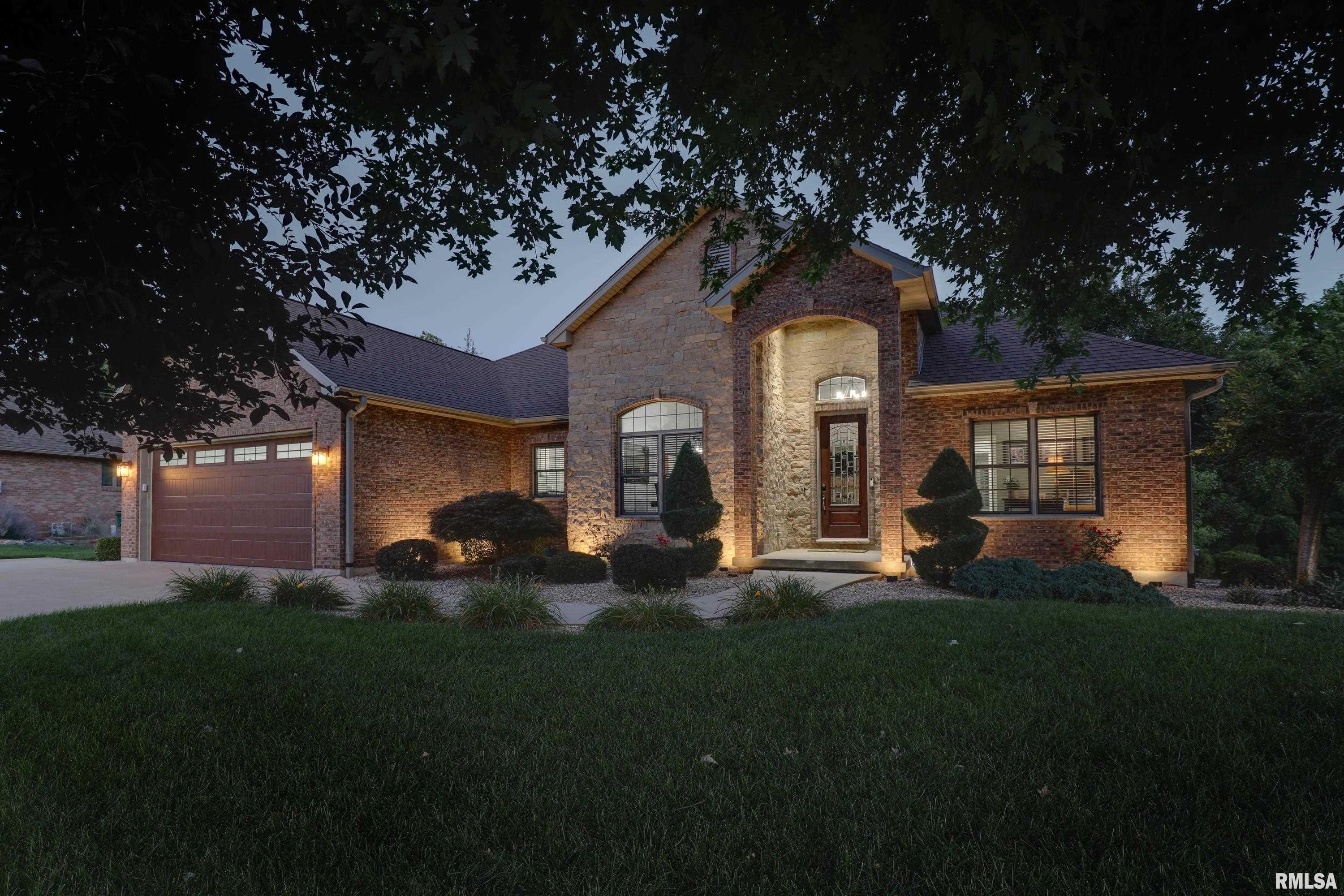 Experience over 3,700 sq ft of luxury living in this stunning brick ranch designed with quality craftsmanship & timeless elegance. From the moment you step through the front door, you'll be captivated by the dramatic 19-ft ceilings, rich hardwood flooring, inviting gas fireplace & expansive open floor plan that creates an inviting atmosphere for both everyday living & entertaining.  The gourmet kitchen is a chef's dream, featuring an abundance of maple cabinetry, solid surface countertops.  A spacious breakfast nook, & a formal dining room perfect for hosting family & friends. Retreat to the luxurious  master suite offering separate dual walk-in closets & vanities. Pamper yourself in a spa-inspired bath complete with an oversized walk-in tiled shower with a rain shower head. The lower level is designed for entertaining, boasting a large family room with a wet bar, beautiful stone accent walls, and a cozy wood-burning fireplace. Stay active year-round in your own dedicated home gym—no gym membership required.  Car enthusiasts & hobbyists will appreciate the finished 2-car attached garage featuring durable Line-X flooring, along with an additional third garage lthat is fully finished, heated, & cooled, making it ideal for a workshop. Step outside to your covered composite deck & peaceful views of the wooded backyard with an abundance of wildlife. Nature lovers will appreciate having one of Quincy's scenic hiking trails just beyond the backyard, providing convenient access.