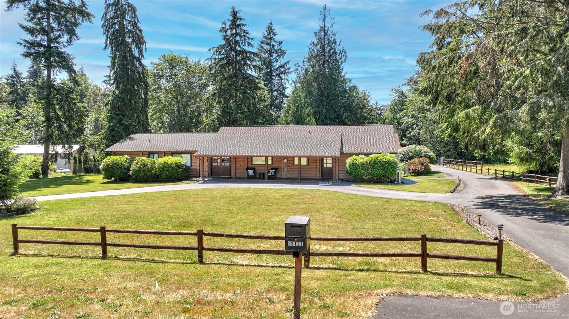 Surrounded by open space & mature landscaping, this log rambler offers a distinctive blend of character & functionality. Situated on just over an acre, the property showcases a flexible floor plan & plenty of room to enjoy the outdoors. Step into large open spaces, oak flooring, warm wood accents, & multiple areas for relaxing or entertaining. The kitchen is equipped with a center island, breakfast bar, SS appliances, built-in desk area, & generous storage. The dining area connects seamlessly to the main gathering rooms, creating an easy flow throughout the home. The primary suite includes a private ¾ bath & dual closets, while additional bedrooms provide versatility for a variety of uses. Interior highlights include ceiling fans, double-pane windows, a pellet stove, & electric heating. Recent improvements include a furnace installed in 2023 & water heater installed in 2024. Outside, the level grounds offer a fully fenced yard, garden space, paved access, & abundant parking. ~18' x 25' detached shop provides an ideal setting for projects, storage, or hobbies. The detached 2-car garage includes a 220-volt outlet, while covered RV parking adds even more flexibility. Add'l items conveying with the property include a John Deere 15 HP liquid-cooled riding mower, a 2-cycle grass trimmer, & a CAT 7500 generator with an electrician-prepared connection. Combining usable acreage with a convenient Kent location, this home is just minutes from shopping, dining, & major commuting routes.