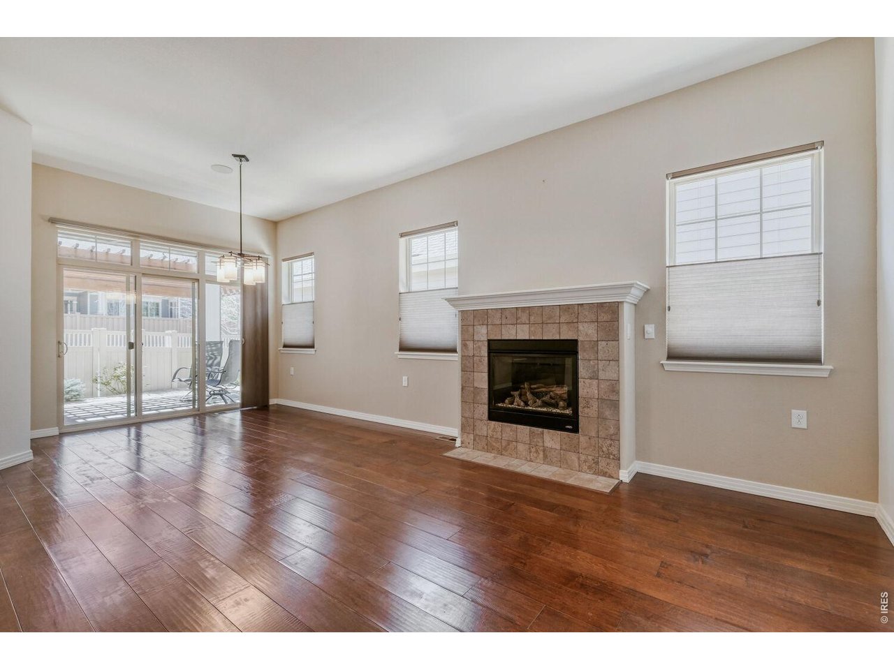 Built in 2012 and located in the Steel Ranch subdivision of Louisville, this meticulously maintained home offers a practical and open floor plan. The main level features hardwood flooring, a gas fireplace, a dedicated office behind French doors, and an additional den. The kitchen includes newer stainless steel appliances, cherry cabinetry, quartz countertops, and a breakfast bar. The primary bedroom features a tray ceiling and large windows, while the finished basement adds a spacious family room and an additional bedroom. Enjoy the inviting front porch overlooking the park, as well as the covered rear patio featuring a ceiling fan and outdoor speakers, perfect for relaxing or entertaining. Additional features include built-in ceiling speakers in the living room, den, and patio areas, a tankless water heater, and a whole-house humidifier integrated with the furnace system for added comfort. LeafFilter gutter guards with a transferable warranty provide added peace of mind. This move-in-ready home fronts the park and is located in a quiet neighborhood near local trails and downtown Louisville.