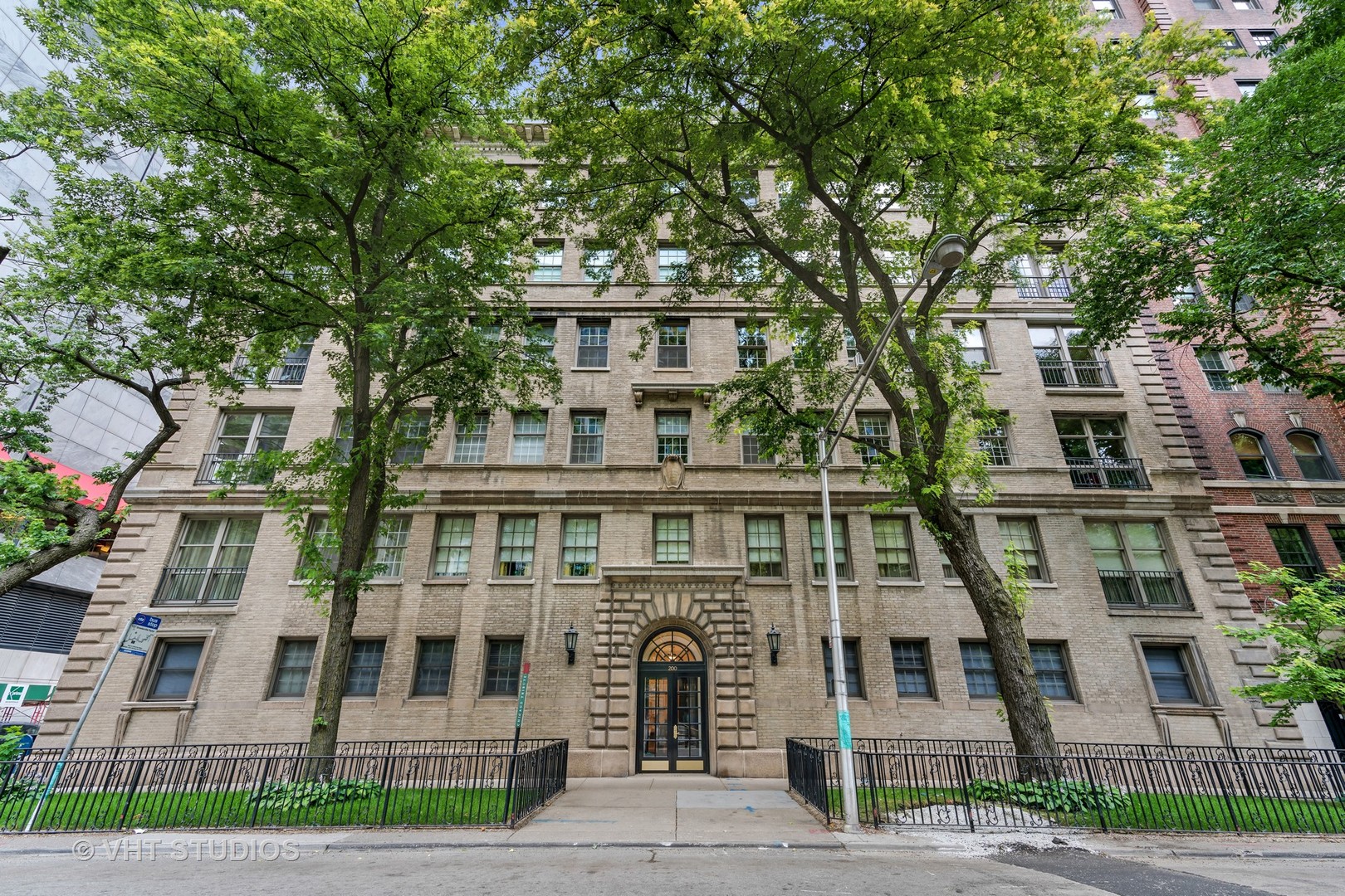 For those seeking privacy, space and elegance, this stunning co-op is the perfect fit. With only two homes per floor and ten total in the building, it truly lives like a single family home. High ceilings with crown molding, grand room sizes, built-in cabinetry, a wood burning fireplace with gas starter and hardwood floors throughout. The living room opens seamlessly to the dining room where you can entertain in style! The Butler's Pantry ideal for in-unit laundry with an abundance of storage adjacent to the kitchen and dining rooms. Open the 3rd bedroom to the kitchen or maintain as a guest room/office. All bedrooms are en-suite. Freshly painted in a neutral color with rich, mahogany stained wood floors. Flooded with natural light from a wall of south facing windows, enjoy the tree top views of the MCA and Lakeshore Park. Mies van der Rohe maintained his home in the building for nearly 30 years! Rental parking for multiple cars steps from the back door.  Financing allowed. Dogs welcome. Huge storage on-site. Estate sale - selling As Is. Home does require freshening.