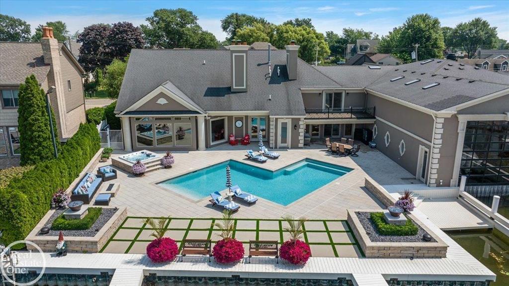 Completely updated One-Of-A-Kind custom-built home on the Black Creek Lagoon w/a 55' enclosed boat house & 7 additional boat wells. This designer showcase home has been updated with all of today's design trends and colors. Beautiful built-in swimming pool with fire pit & built in hot tub offering great views overlooking the Black Creek. Almost 8,000 sq. ft. of finely appointed living area featuring a grand 2-story entrance foyer w/wrought iron staircase. Luxurious 1st floor owner's suite w/attached screened-in porch & luxury bath. Awesome great room w/40' wet bar & walls of windows overlooking water. Gourmet chef's island kitchen. 2nd floor apartment style suite w/full kitchen, bedroom, bath & living room (great for in-law suite) & additional 3 bedrooms w/private bathrooms.  3.5-car heated attached garage w/extra large driveway for guest parking. Bath servicing swimming pool has steam shower. This is truly a boaters/entertainer's dream home with the waterfront bay location only minutes from Lake St. Clair.