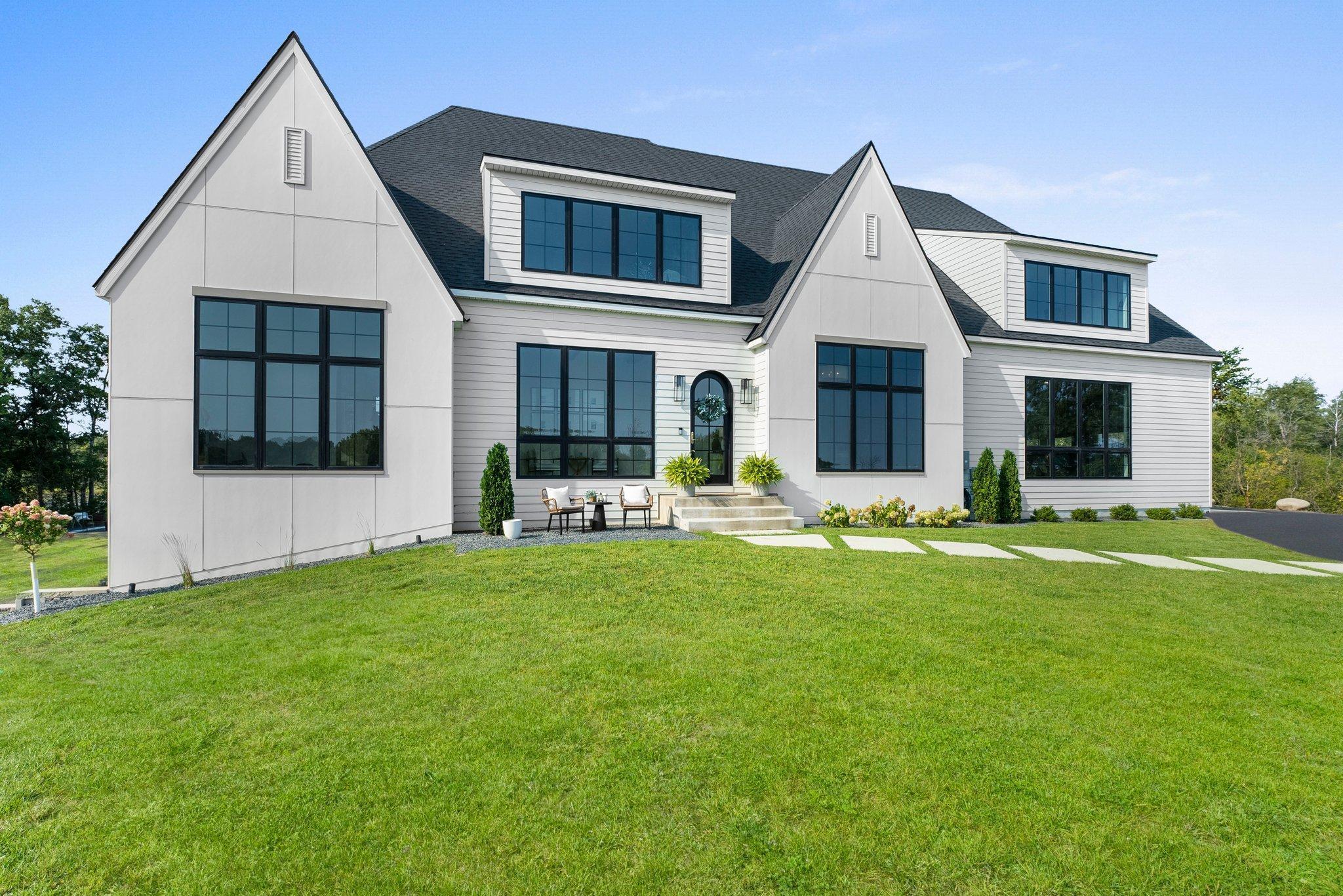 This custom-built luxury home, completed in 2022, sits on an expansive 4.7-acre lot, offering a serene and private retreat. Step inside to find a thoughtfully laid-out main level, featuring a gourmet kitchen, an inviting dining area, and a grand great room, all designed to maximize your enjoyment of the picturesque surroundings. The main-floor primary suite is a tranquil retreat with vaulted ceilings, large
gridded windows overlooking the backyard and pond, and a tiled electric fireplace. The luxurious ensuite bathroom is a spa-like experience. The main level offers a convenient 3/4 bathroom with direct access to the backyard and potential pool area and a versatile mudroom/den with storage lockers and drawers for storage.  The upper level offers a serene and versatile retreat. A spacious family room equipped with a projector and screen, laundry room and 2 generously sized bedrooms connected by a jack & jill bathroom. The lower level is an entertainers dreaming boasting a large living room with an electric fireplace, a full size wet bar and 29x21 recreational room ensuring you will always be ready to entertain guests. With Marvin windows and stunning White Oak flooring throughout, this home is a masterpiece of craftsmanship and modern design. The exterior boasts durable Hardie siding, while inside, every detail has been meticulously chosen, from the quartz countertops throughout to the exquisite finishes.