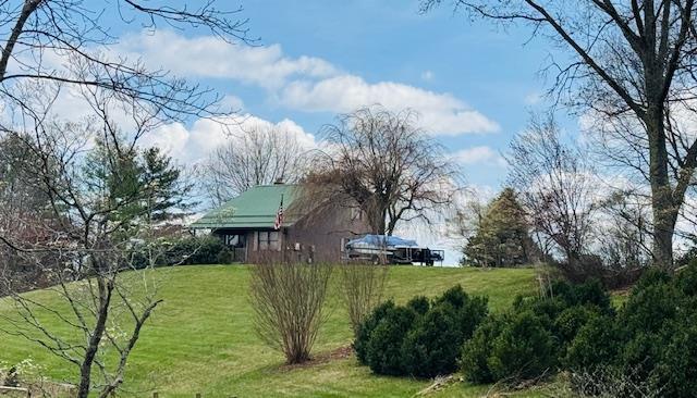 Charming 3-bedroom, 2-bath bungalow nestled on 1.92 acres of beautifully maintained gardens and established orchards, offering a rare blend of natural beauty and peaceful living. Enjoy breathtaking long-range mountain views from every window, creating a serene backdrop throughout the home. This inviting property features 1,596 sq ft of comfortable living space with a functional layout, plus an additional 876 sq ft. heated unfinished walk-out basement—ideal for future expansion, workshop space, or additional living quarters. Solar power for efficiency ! Located just minutes from the New River in desirable Fries, VA, this property offers the perfect balance of privacy and convenience, with easy access to outdoor recreation including fishing, kayaking, and hiking. 10 mins from Galax and 10 mins from Fries for access to the New River trail 52+ miles  trails along the water! This property has convenience but seclusion!  Call today for your showing  A unique opportunity to own a scenic retreat with room to grow—perfect as a full-time residence, vacation getaway, or investment property.