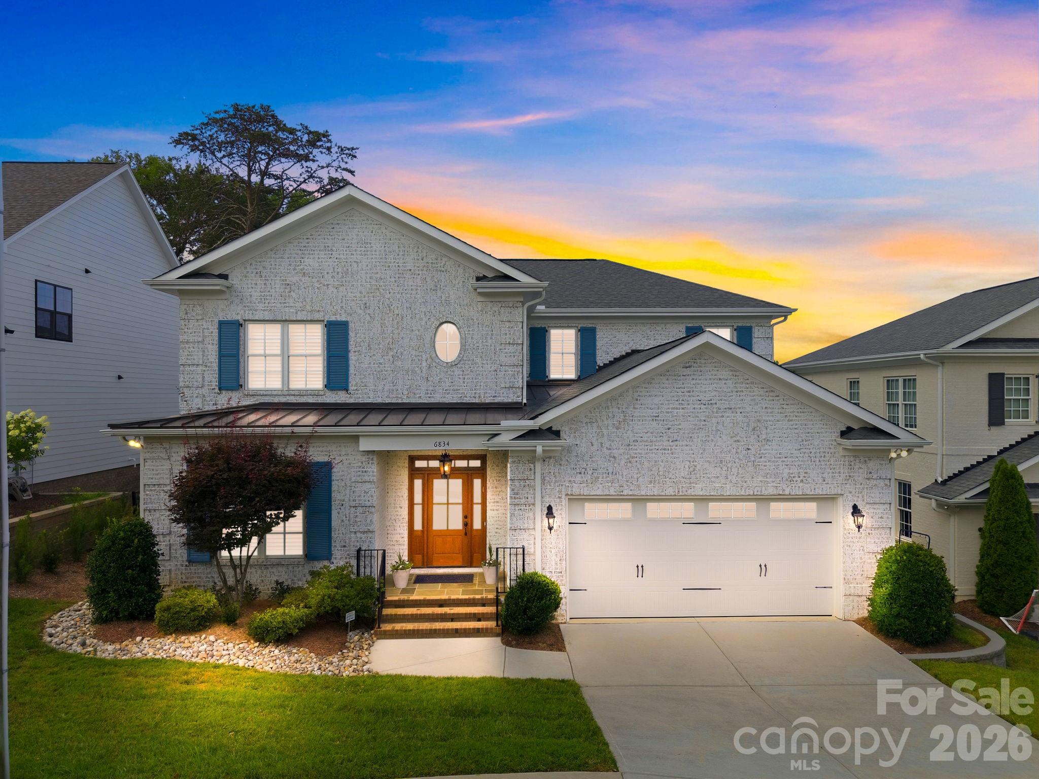 Immaculately maintained and barely lived in, this full-brick residence offers modern finishes, timeless upgrades, and a highly desirable floor plan in sought-after South Charlotte. Built by Castleman Construction, the home showcases 10-foot ceilings, hardwood floors throughout, solid core doors, extensive moldings, wood plantation shutters throughout, custom window treatments, and a premium lot.Designed for both everyday living and entertaining, the main level includes a welcoming foyer, office or sitting room, formal dining room, spacious great room, breakfast area, and a chef’s kitchen with a large center island, quartz countertops, KitchenAid appliances, gas range, convection oven, built-in microwave, stainless steel refrigerator, dishwasher, disposal, custom cabinetry, and abundant counter space. The great room features a coffered ceiling, contemporary cast concrete mantel, custom floating console, Hunter Douglas Roman shades, designer draperies, and views of the covered porch and backyard.The main-level primary suite offers a private retreat with a vaulted ceiling, custom walk-in closet, and spa-like bath featuring a freestanding soaking tub, dual vanities and a walk-in shower.Upstairs, the thoughtful layout offers a private bedroom, full bath, and loft on one side, while two additional bedrooms connected by a Jack-and-Jill bath are positioned on the other. At the center, a large bonus room provides excellent flexibility for guests, work, play, or media space. All bedrooms feature custom walk-in closets and oversized windows with wood plantation shutters.Outdoor living is a true highlight with a bluestone covered rear porch, electric porch screens, new outdoor fan, updated landscaping, and a fenced backyard designed for relaxing and entertaining. Additional upgrades include a Swarovski crystal light fixture in the powder room and primary bathroom, custom millwork cabinetry in the mudroom, tankless water heater with hot water circulator, whole-house water filtration system, sprinkler system, alarm system, and French drain.Ideally located in Ashton Ridge near the Arboretum, SouthPark, Ballantyne, shopping, dining, and everyday conveniences, this beautifully maintained home offers a rare blend of quality, luxury, and convenience. Welcome home to 6834 Providence Lane W.