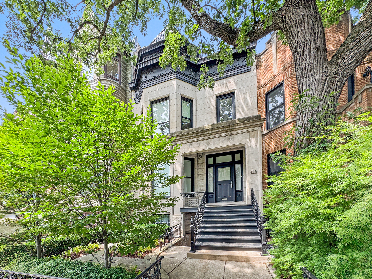 Set on one of Lakeview's most picturesque blocks, this elegant graystone was gut-renovated by one of Chicago's leading modernist architects as his personal residence. The result is a masterfully designed, gently lived-in home offering a highly functional floor plan, sophisticated contemporary finishes, and a refined sense of style.  The main level is designed for both entertaining and everyday living, with expansive walls and gallery lighting ideal for displaying artwork. The open-concept kitchen was created as a true working space, featuring stainless steel and marble countertops, dual sinks, high-gloss lacquered cabinetry, premium appliances, and a custom oversized island.  The kitchen opens seamlessly to a stunning rear terrace with a louvered retractable roof, infrared heaters, irrigated planters, stacked stone privacy walls, a built-in grill, wall-mounted television, and a natural gas fire pit-creating an inviting, all-season outdoor living space.  Upstairs are four bedrooms with custom closets, including a spacious primary suite, two full baths, an office, and a secondary laundry center. The lower level includes a large recreation room, a den/guest suite with full bath, a well-appointed laundry room, and a bonus space currently used as a workshop.  This architecturally significant home makes a striking first impression with its limestone facade, black slate turret, and landscaped front garden. The full renovation included new mechanicals, plumbing, and electrical systems throughout. Additional features include limestone and hardwood floors on the main and upper levels, two fireplaces, sleek modern baths, dual laundry centers, solid-core doors, architectural lighting, Lutron Pico motorized blinds, zoned HVAC with central humidification, landscape lighting, and a 2-car garage.  Ideally located with easy access to East Lakeview and the Southport Corridor dining, shopping, and everyday conveniences, this home is also just a block from Weisman Park and Playground.