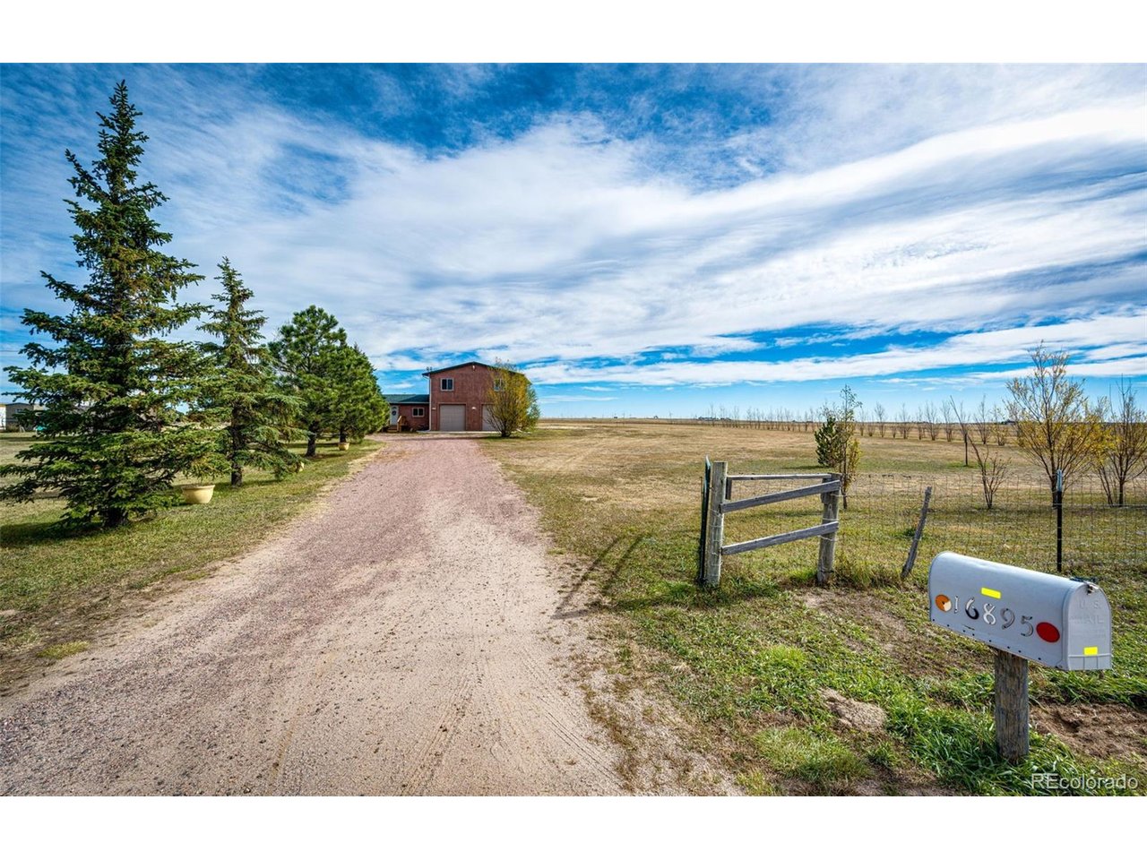 Located just about 5 miles outside of Simla, this unique property offers 5 bedrooms, a 3-car garage with pull-through ability, and over 35 fenced acres of opportunity! Whether you're dreaming of starting a hobby farm, growing your own garden, or simply enjoying wide-open spaces this property offers room to make those dreams a reality.  Don't forget the view of Pikes Peak!The heated garage is a standout feature, equipped with 220-volt power and radiant floor heating to keep the family mechanic comfortable while working through those chilly winter months. Above the shop, you'll find two bedrooms, a full bathroom, and a spacious great room filled with potential. An additional bonus room with its own exterior entrance makes an ideal home office, studio, or private workspace.Inside, enjoy a large living room featuring two garden windows and cozy wood-burning fireplace, perfect for gathering on cold evenings. The open concept between the living room and dining area offers easy access for entertaining and connecting with family and friends. Convenient main-level laundry adds to the home's functionality.Outside, mature trees provide a beautiful setting, while the new front porch and back deck offer wonderful spaces to relax and take in the surroundings including your own view of Pikes Peak! Two storage sheds, an empty trailer and lean-to provide plenty of additional storage for equipment, tools, and outdoor belongings.Fresh updates include all-new interior paint and professionally cleaned carpeting throughout, giving the home a fresh, welcoming feel.With acreage, versatile living space, an impressive heated shop, and endless possibilities, this property offers a rare opportunity to enjoy country living with room for work, play, and everything in between!