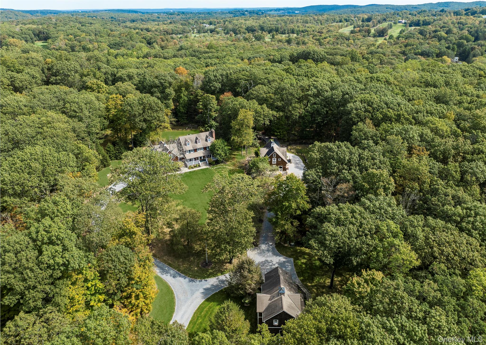 Windward Mark Farm.
An exceptional 9.4-acre equestrian estate on one of North Salem’s premier dirt roads, surrounded by renowned bridle trails and conservation land. This remarkable property includes a gracious four-bedroom main residence, an exquisite one-bedroom-plus carriage house, and a handsome Amish-built horse barn and shed row—totaling six stalls with a heated tack room, feed room, outdoor wash stall, and hayloft.
Equestrian amenities include a 110' x 180' fenced riding arena with Lawton Adams Travel Rite footing, a grass dressage field, cross-country jumps, rolling grass paddocks, and direct access to the trail system—making this a true lifestyle property.
The main home welcomes you with a charming front porch overlooking mature gardens and apple trees. Inside, elegant living spaces flow seamlessly: a formal living room with a wood-burning fireplace, a music room with French doors, and a grand dining room perfect for entertaining. The gourmet kitchen, featuring a center island, dining area, and sliding glass doors to a spacious deck, opens directly into a cozy family room with a stone fireplace, vaulted ceilings, and abundant natural light.
A laundry/mudroom with private stairway leads to a versatile suite—ideal for guests, a nanny, or home office. The luxurious primary suite offers a vaulted ceiling, sitting room, spa-like bath, and walk-in closet. Two additional bedrooms and a full hall bath complete the second floor, while the third floor provides flexible space for a gym, office, or storage. Additional features include a full walkout basement and a three-car garage with EV charger.
The stunning carriage house offers an open layout with a double-sided stone fireplace, living and dining areas, eat-in kitchen, office, bedroom, and two full baths. With a private lawn, terrace, and attached two-car garage, it provides an excellent rental opportunity or perfect guest accommodations.
Windward Mark Farm is the rare opportunity to enjoy refined country living, minutes from downtown Ridgefield and top horse show venues—all on a quiet, scenic country lane.