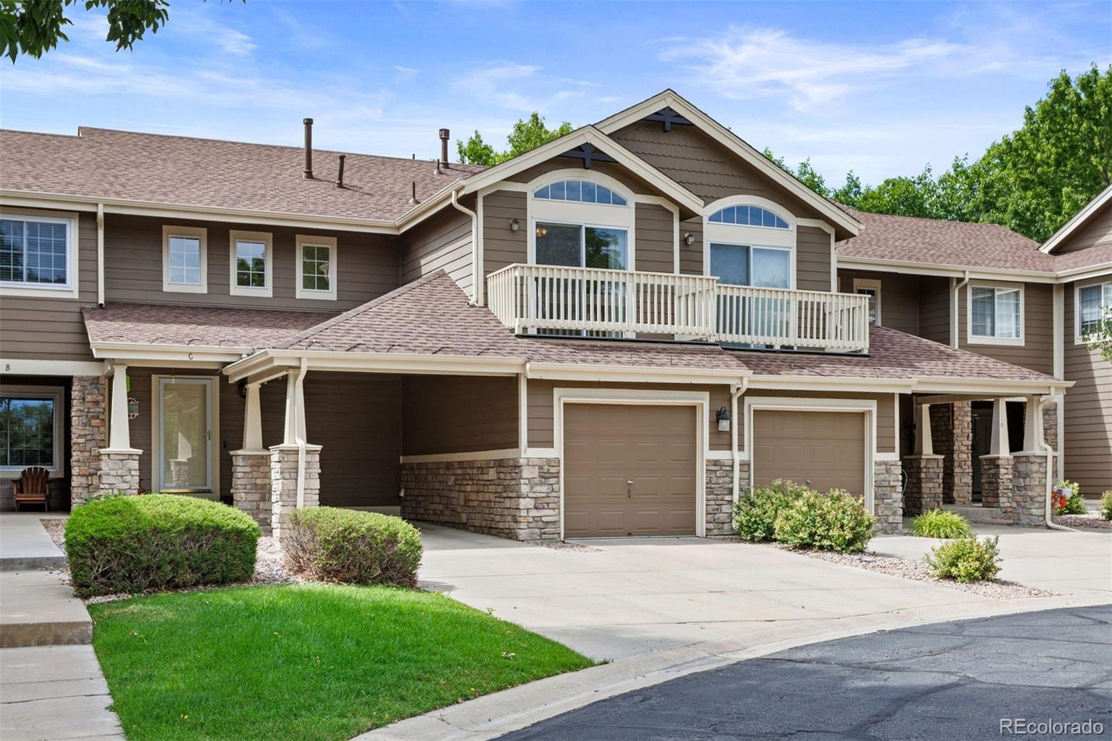 Attached garage and private carport, with clubhouse amenities just around the corner. For low-maintenance living done right, you’ve found the townhome! No multiple flights of stairs to haul groceries up, just a couple of steps between the car and the kitchen counter. A covered front porch welcomes you in, opening into a comfortable living space centered on a gas fireplace with stone tile surround and wood mantle, set beneath a two-story ceiling and clerestory windows that carry light down the staircase. A large window frames the patio and yard beyond. The kitchen opens directly off the living space, with a large center island with seating, a GE® range with double oven, and ample prep and storage space. The dining room is spacious and steps straight out to the patio through a sliding door. The covered rear patio opens onto a gated, private backyard backing to a grassy greenbelt. Upstairs, a loft overlooks the living room below, flexible enough for a home office, gym, playroom, or additional living area. Two bedrooms and two full baths complete the level, including a primary suite with a private balcony, vaulted ceiling, and en-suite bath with jetted tub. The finished basement adds a spacious rec room and a third bedroom, suited to guests, a roommate, or a quiet workspace. Through the master association, residents enjoy Stroh Ranch's Creekside Recreation Center, featuring an indoor lap pool, outdoor pool and kiddy pools, a gym, racquetball courts, tennis, playgrounds, plus walking and biking trails. HOA dues cover lawn care, trees, water, trash service, and front and back concrete. Location is central to Parker, with easy access in every direction.