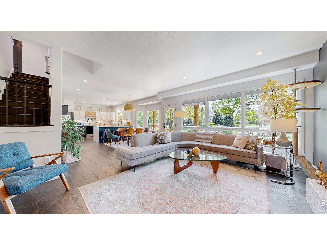 Welcome to this beautifully updated home in Country Meadows, ideally positioned near trails, golf, medical, shopping, and commuter access. Set along a quiet residential loop and backing to an unobstructed greenbelt view, this home blends refined style, natural light, and flexible living spaces designed for the way people live today. The inviting main level features a bright, open living area with a modern flow and expansive windows, French oak wide-plank floors, and a gas fireplace. The kitchen is stylish and functional, with quartz countertops, resurfaced cabinetry, subway tile backsplash, generous prep space, and easy flow for everyday living and entertaining. Upstairs, the spacious primary suite offers a fully remodeled spa-inspired bath with designer finishes, soaking tub, and walk-in shower. Two additional bedrooms share a full bath, while the upgraded laundry room and hidden bookshelf door open to a versatile flex room ideal for an office, studio, guest retreat, or 5th bedroom option. The recently finished basement adds exceptional livability with a welcoming entertaining space, stylish wet bar with beverage fridge, cozy under-stair office or reading nook, additional bedroom, full bath with walk-in shower, and flexible open area for movie nights, workouts, or casual gatherings. Outside, the professionally landscaped backyard opens to a private and bucolic view with protected open space framed by classic white pasture fencing, creating a rare sense of privacy and connection to the outdoors. Near Bamford Elementary and within the Fossil Ridge High School district, this home offers thoughtful updates, memorable design, and everyday functionality in a highly convenient location.