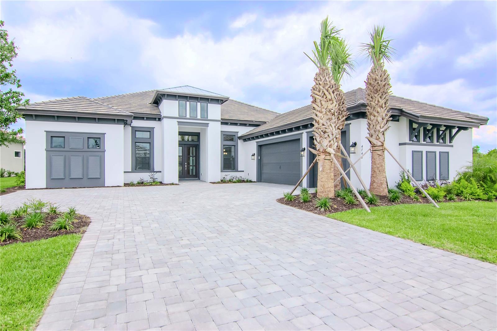 Under contract-accepting backup offers. The Beacon is a floor plan that does more than just impress. Located in Wiregrass the heart of Wesley Chapel. This 3,690 square foot home presents three en-suite bedrooms all with walk-in closets, a bonus room, an office and an extra large three-car garage as well as a lineup of distinguished upgrades. When entering through the front door the 14 foot double tray ceilings give an immediate sense of grandeur and spaciousness. The main living area completely opens up, bringing the outside in. The kitchen is stacked with 60+ inch all real wood upper lighted cabinets with glass front doors. The lower cabinets have wooden pull outs and drawers to make access an ease. There is over and under cabinet accent lighting mounted throughout the kitchen. There is eight burner gas range with commercial sized hood, an in-wall oven and microwave, two wine chillers, a huge island with a dishwasher and full size lower cabinets under the breakfast bar. The walk-in pantry is upgraded with wooden shelves. All kitchen appliances are Monogram Cafe Series. The office offers tons of natural light. The back of the property is the bonus room that opens up to the outside as well. This home is an entertainers dream with the heated pool, spa and outdoor kitchen. There is so much to offer in this wonderful, private property.