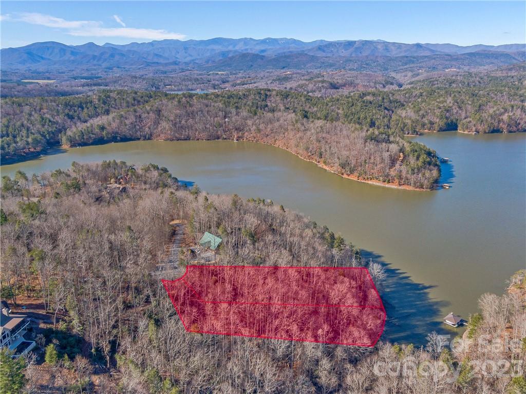 Tranquility awaits: rare double waterfront lot with mountain and lake views in a quiet cove in The Arbor at Lake James. Build your forever home or lake getaway. Meets criteria for dock permit *buyer to verify. Enjoy the privacy and serenity of this exclusive gated community with walking trails and recreational areas!