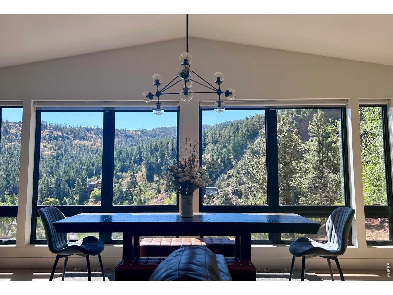 Imagine living where your backyard is one of Colorado's most iconic landscapes. Set on over 1.3 private acres bordering Eldorado Canyon State Park, this extraordinary home offers direct access to world-class hiking, climbing, and breathtaking scenery, all just 12 minutes from South Boulder.Thoughtfully reimagined in 2022, the home blends sophisticated contemporary design with the warmth of mountain living. The extensive architectural renovation transformed the layout to maximize natural light and showcase the spectacular canyon views, creating an open, inviting floor plan centered around a beautifully designed chef's kitchen with seamless indoor-outdoor living.Opportunities like this are exceptionally rare. Fully renovated Canyon homes of this caliber, with immediate access to protected open space and such close proximity to Boulder, seldom come to market. Every detail has already been completed, allowing you to simply move in and begin enjoying the lifestyle.Wake up to dramatic canyon views, spend your afternoons exploring miles of trails, and return home to a beautifully crafted residence where modern luxury meets the Colorado lifestyle. This is mountain living without compromise. Convenient school bus pickup for Mesa Elementary, Southern Hills Middle School, and Fairview High School is located in front of the town post office.