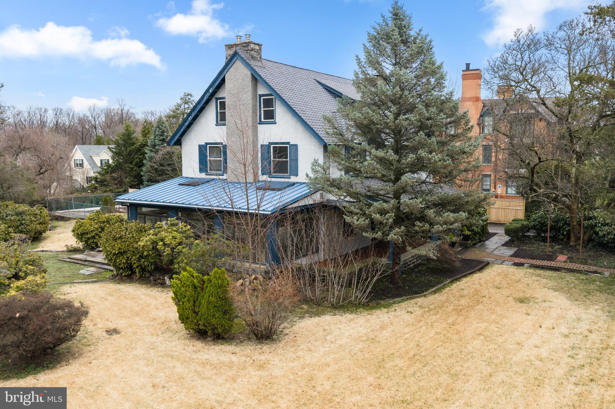 Tucked behind a lush landscape of mature trees and privacy hedges on the corner of Montgomery Avenue and Edgewood, one of Ardmore's most coveted streets, this classic colonial home beckons you to step inside and discover its wealth of history and charm. Just steps from the vibrant shops and restaurants of Suburban Square, this home is also located within the choice zone of the award-winning Lower Merion School District.  As you approach the residence, the grand covered front porch and timeless facade set the stage for the delightful surprises that await. Step through the elegant foyer, complete with arched cased openings and rich wood paneling, and you'll be captivated by the home's original details and craftsmanship.  Original hardwood floors lead you into the formal living and dining rooms, where decorative fireplaces and built-in cabinetry create a sense of warmth and sophistication. Step through the French doors and you'll discover a sun-drenched sunroom, complete with a stone fireplace and tiled floors - the perfect spot to relax and unwind.  Nearby, the spacious kitchen and generous laundry/mudroom offer ample storage and the potential for a second powder room, providing the perfect blend of function and flexibility. Tucked discreetly under the foyer stairs, you'll also find a charming powder room, adding a touch of convenience to the first floor.  Upstairs, the 3 gracious bedrooms on the 2nd floor and 2 additional bedrooms on the 3rd floor offer plenty of space for family and guests.  The primary suite provides a true retreat, complete with a fireplace and sitting room.  This Classic colonial is brimming with potential, waiting to be lovingly restored and updated by a new owner with an appreciation for the past and a vision for the future. Embrace the possibilities and make this Ardmore diamond in the rough your own.