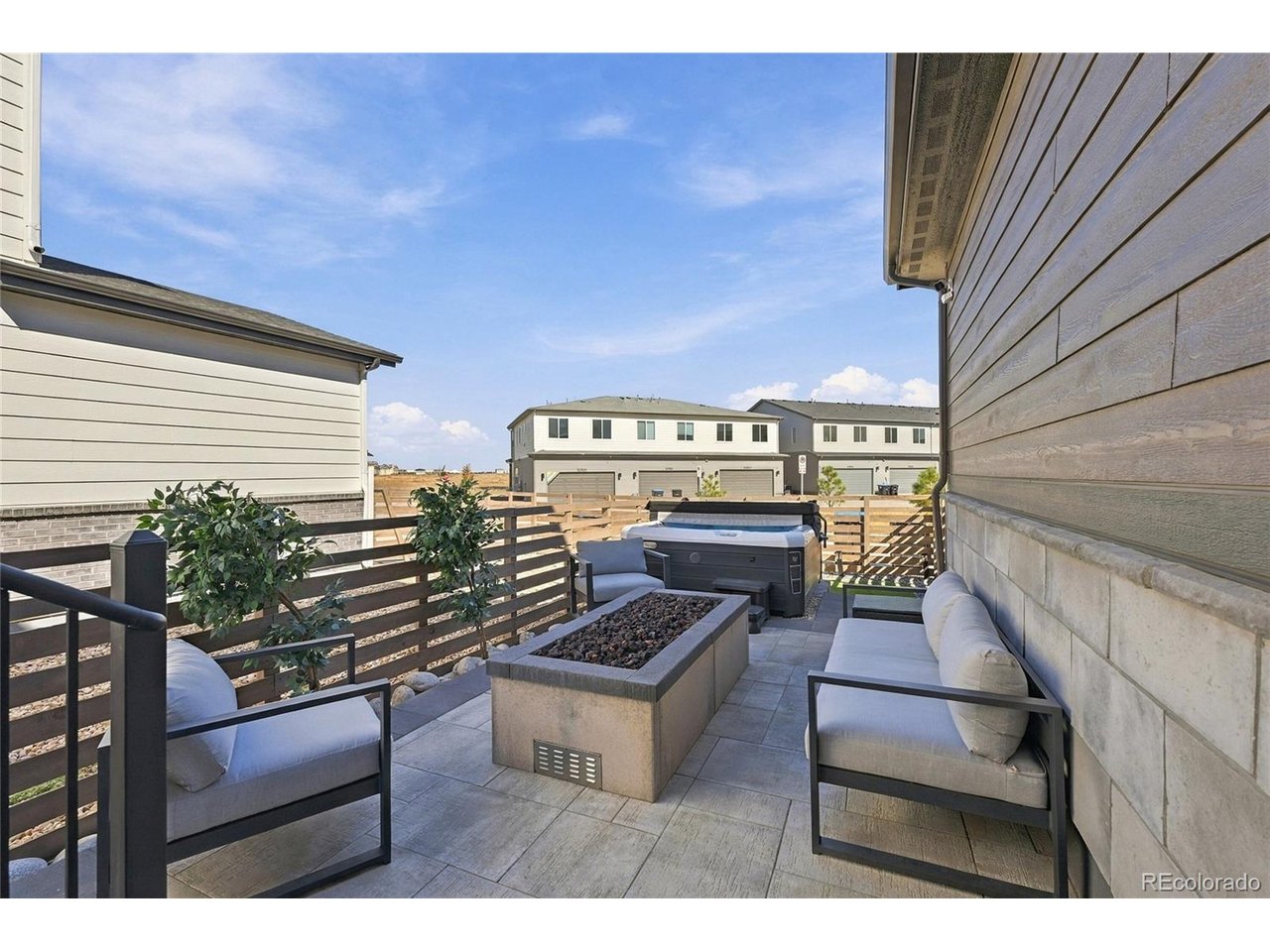 $10,000 Buyer Credit with acceptable offer! Better than new and move-in ready! Built in 2025, this exceptional home blends contemporary style, designer upgrades and versatile living spaces. Located directly across from open space, this 4-bedroom, 3.5-bath home is the one you've been looking for.Nine-foot ceilings create an airy feel throughout. The inviting great room features a cozy gas fireplace, while the gourmet kitchen impresses with an oversized upgraded quartz island, single-bowl stainless-steel sink, walk-in pantry, 42" light gray cabinetry, elegant hardware, touch faucet, gas range and stainless-steel Whirlpool appliances. Stylish lighting, ceiling fans and an open stair railing add designer flair. Upstairs, the spacious primary retreat features a walk-in closet and luxurious bath with double sinks and a fully tiled shower. 2 secondary bedrooms, full bath, a loft and convenient second-floor laundry complete the upper level. The basement is fully finished with a game room, bedroom and full bath. The backyard is designed for effortless enjoyment, featuring low-maintenance artificial turf, a fully fenced yard with 5-foot semi-privacy fencing and a covered patio. Patio furniture, a firepit and an almost-new hot tub are included, creating an inviting outdoor retreat for relaxing and entertaining. Front landscaping and irrigation add curb appeal.Smart features include Schlage keyless entry, a Wi-Fi-enabled garage door and programmable smart thermostat. Energy-efficient highlights include a Rinnai tankless water heater, Low-E windows, Carrier furnace and central A/C. The 2-car garage includes standard EV charging. Fridge, washer, dryer included!Painted Prairie offers an exceptional lifestyle with miles of walking trails, playgrounds, community gardens, a dog park, neighborhood gatherings, farmers markets, coffee carts, outdoor festivals and concerts. Enjoy modern comfort, exceptional space and an inviting outdoor oasis in this remarkable home!