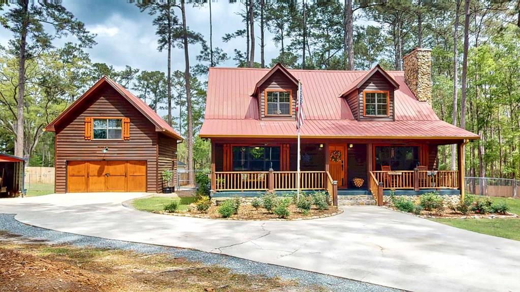 Step into a storybook setting with this charming rustic cabin tucked away in Plantation Woods on the south side of Thomasville, where warmth and thoughtful updates meet peaceful acreage. From the moment you enter, you're greeted by rich pine floors, soaring ceilings, and a striking stone fireplace that anchors the living space with character and comfort. The kitchen and breakfast area offer an easy, inviting flow, while the main bathroom feels like a retreat with its stone-wrapped tub and shower. This home isn't just beautiful, it's been extensively improved. The kitchen has been upgraded with new cabinets, granite countertops, backsplash, and a full suite of newer appliances including dishwasher, refrigerator, and microwave, plus a new garbage disposal. Downstairs features updated flooring throughout, along with new bathroom cabinetry, sinks, and hardware. You'll also find a newer hot water heater, new water softener, and updated lighting and ceiling fans both upstairs and down. Additional updates continue throughout the property, including all new wired smoke detectors, fresh paint on interior doors, and newly installed porch fans. Outside, the property truly shines. Set on a spacious 1.28-acre lot, the home includes a detached garage plus a fully upgraded "man cave" space featuring brand new sheetrock, flooring, lighting, and its own split unit AC. The exterior has been recently stained, and the land has been cleared and enhanced with a beautifully landscaped rose garden out front. A brand new privacy fence and chain link fencing, valued at approximately $13,000, adds both function and appeal. With a large sun porch, rear screened porch, and a long list of meaningful upgrades already completed, this home offers both charm and value. It's the kind of place where the big-ticket items are already handled, letting a new owner simply move in and enjoy the setting, the space, and the lifestyle. Call today for your private tour!