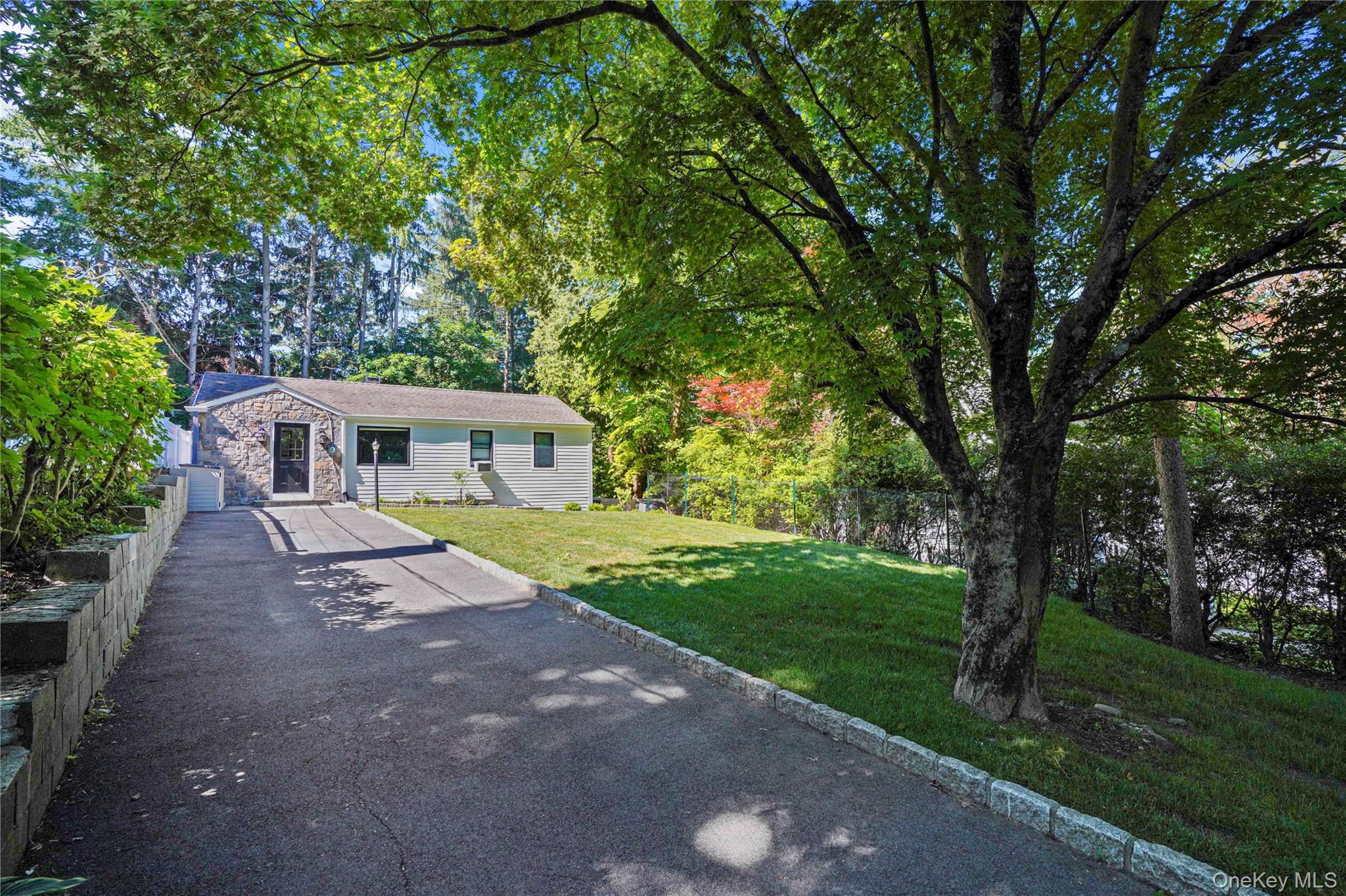 Experience the best of convenient living in this stylishly updated 3-bedroom home, perfectly situated in a walk-to-all neighborhood near the train, schools, shopping, and library. This meticulously maintained property boasts significant modern upgrades, including double pane windows, Hardiplank siding, and a spacious Trex deck overlooking a private, flat, grassy backyard. Inside, enjoy hardwood floors and LED lighting throughout, leading you into a bright living room with crown molding and large windows that frame the deep front yard. The kitchen is a chef's delight, featuring quartz countertops, a deep stainless steel sink, and stainless steel appliances, including a gas range and French door refrigerator. The king-size primary bedroom has an en suite bathroom and offers direct access to the deck, while the walk-out lower level adds versatile living space, complete with a private office, a third bedroom with an en-suite bath, and laundry. This home is ready for you to move in and enjoy!