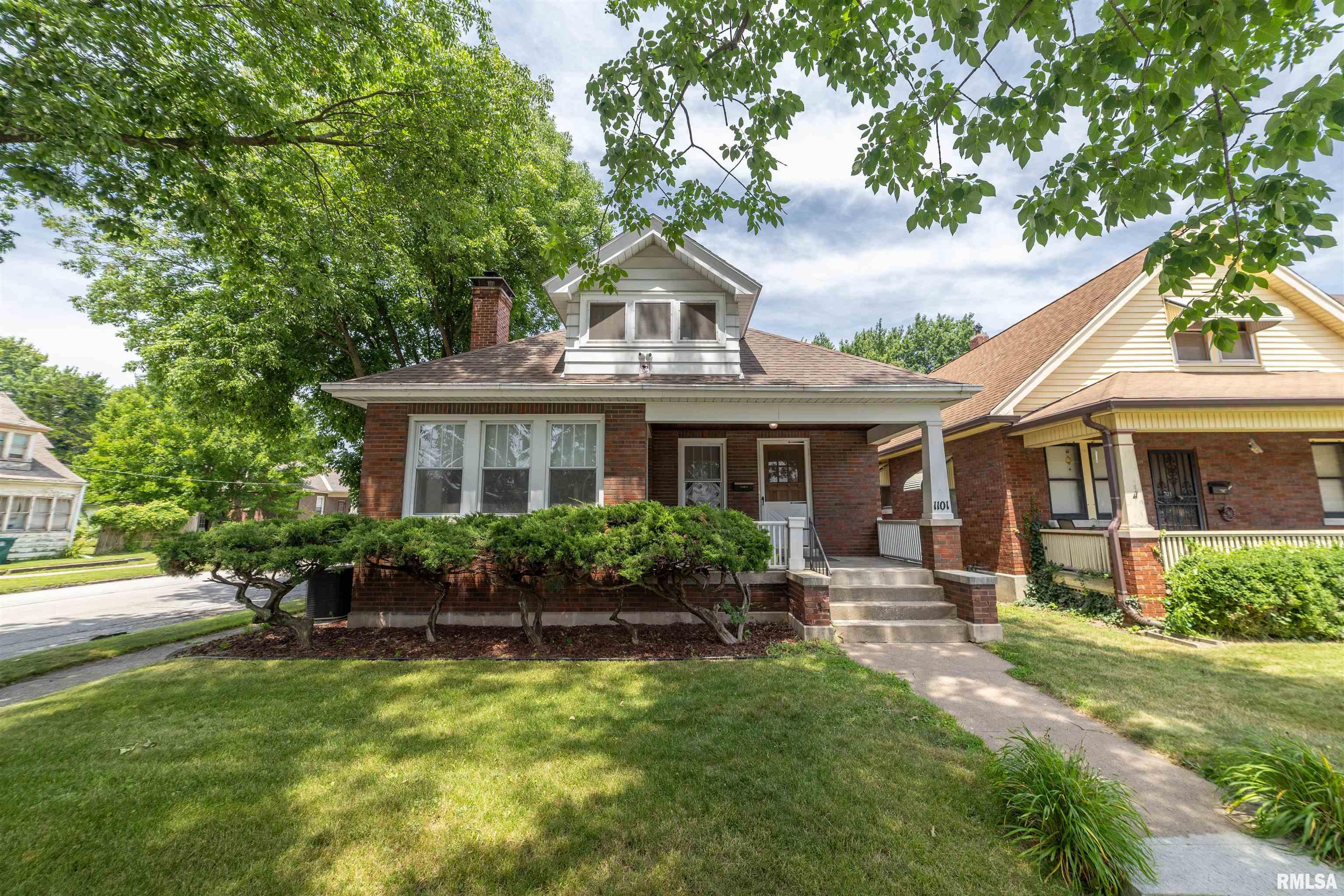 Pride of ownership shines throughout this wonderful 2-bedroom brick bungalow situated on a corner lot! This beautifully maintained home has seen numerous updates since 2020, including electrical, water lines, bathroom, paint throughout the main floor, updated kitchen, gas fireplace, water heater, and some replacement windows. You'll love the high ceilings, beautifully refinished hardwood floors, and the warmth and character this home offers. The full, expandable attic provides an excellent opportunity to add additional living space, while the full basement has been used as a home office and offers endless possibilities for work, recreation, or storage. Step outside to enjoy the fully vinyl privacy-fenced backyard with a patio, perfect for entertaining or relaxing. A spacious 2-car garage completes this move-in-ready home. A truly well-cared-for property that's ready for its next owner!