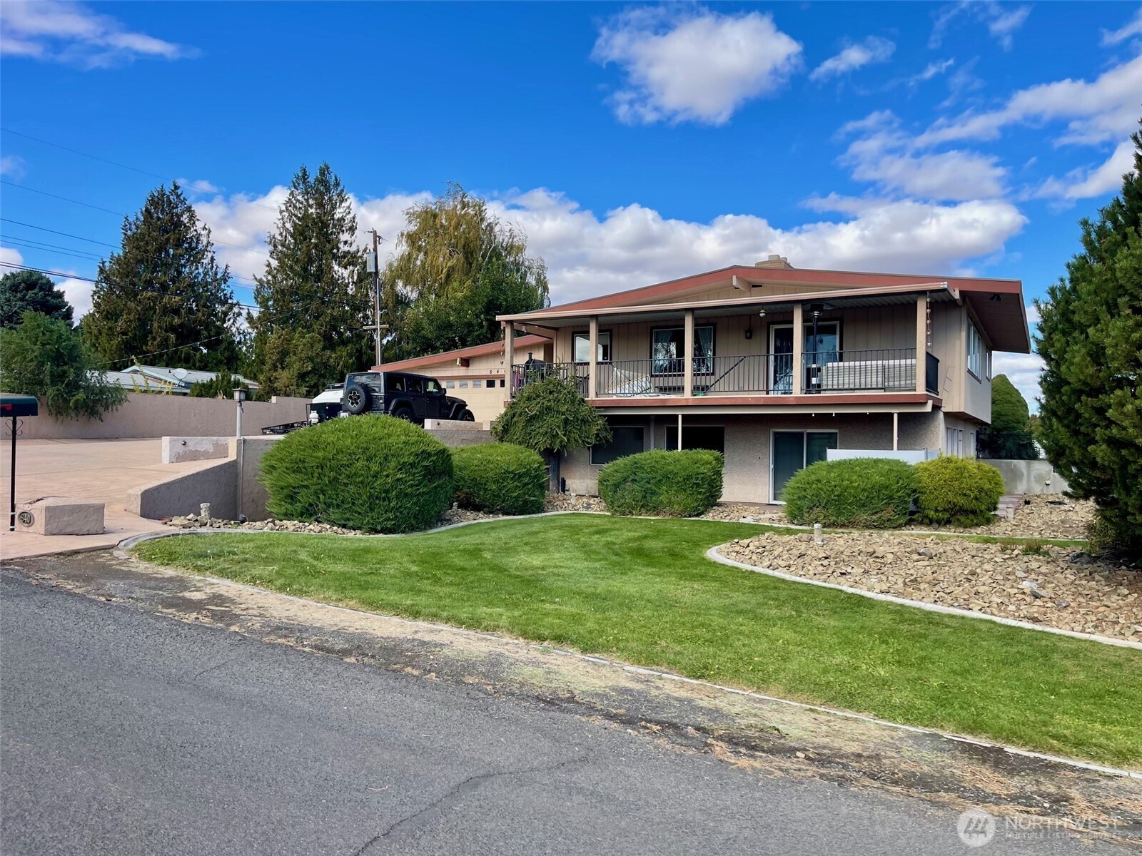 Experience elevated living in this beautifully updated 2,700 sq ft home perfectly positioned on an oversized, fully fenced corner lot with sweeping views of Hole 1 and Tee 2.  This spacious 4-bedroom, 2-bath residence offers exceptional functionality and style. A stamped, oversized driveway provides ample parking, complemented by a 2-car attached garage featuring an electric vehicle charger and a versatile finished bonus room. Enter through a charming covered and gated courtyard into an impressive double-door entry. The heart of the home is a large kitchen with granite countertops, abundant cabinetry, and a generous dining area—perfect for entertaining. The open-concept living room flows seamlessly to an expansive deck, ideal for relaxing and enjoying the stunning golf course views. Both levels feature generously sized bedrooms, while the lower level includes a spacious family room with sliding door access to a private patio, a dedicated office, and abundant storage throughout. Cozy fireplaces on both levels enhance comfort and ambiance year-round. With its thoughtful layout, modern updates, and unbeatable views, this home offers a rare opportunity to enjoy space, privacy, and scenic surroundings all in one. Don’t miss your chance to make it yours.