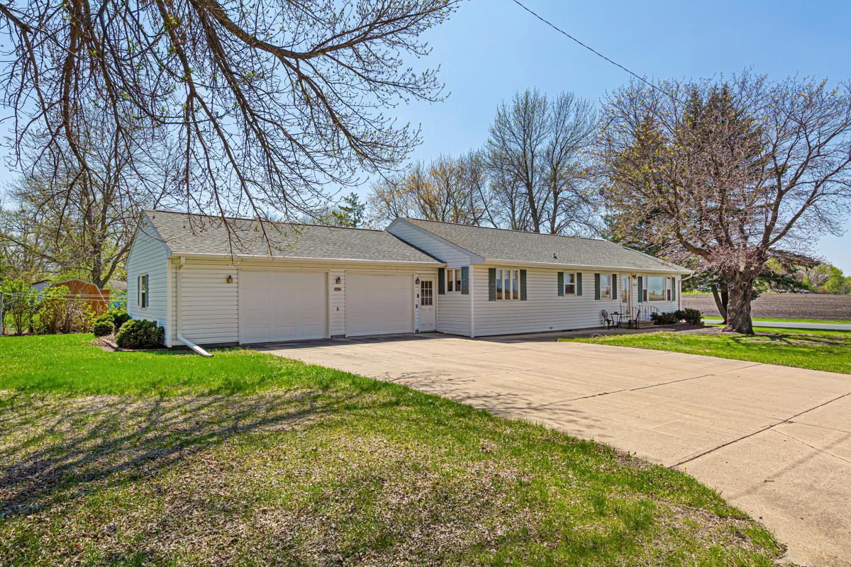 Charming 4 bedroom positioned on a large corner lot, desirable located on the edge of town! Exterior amenities include a new roof, heated and insulated 2 stall attached garage, 10x16 patio with a privacy fence! On the main level you will find an inviting layout with a spacious dining area that leads into the kitchen and a cozy breakfast nook! Kitchen amenities include custom cabinets, Cambria countertops and stainless steel appliances! Main level provides 4 spacious bedrooms and a full bathroom! Lower level consists of a large family room, endless amounts of storage space and rough-in bathroom. Other interior amenities include forced heat and central air. Schedule your private showing today!