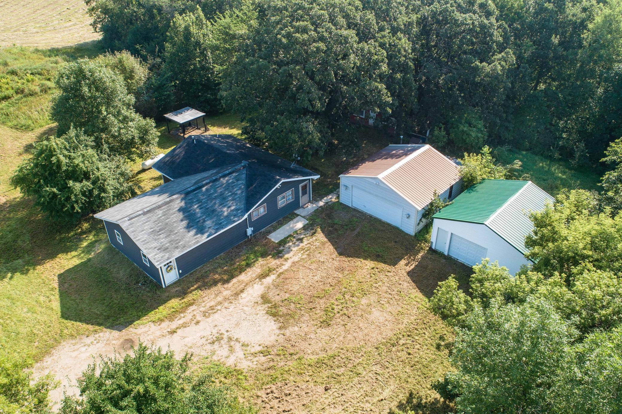 Country living meets outdoor adventure—your rural retreat awaits!  Escape to your own private retreat on just under 35 acres, perfect for hunters, outdoor enthusiasts, or anyone craving the peace of a rural setting. This 3-bedroom, 1-bath home offers convenient main-floor living, featuring a spacious master bedroom with walk-in closet, a large walk-in storage room, and a walk-in pantry for exceptional organization and storage space.  The exterior boasts low-maintenance vinyl siding on the home and one garage, with durable metal siding on the second garage. The land includes a rented hay field, a grassy slough, and an expansive wooded area with ATV trails—ideal for deer hunting or exploring the outdoors. Additional features include a chicken coop, a storage shed near the hay field for equipment, and two detached garages that can serve as parking, workshop space, or extra storage.  Nature lovers will appreciate the variety of fruit trees—plum, pear, apple, and apricot—along with blooming lilac trees that enhance the property’s charm. Located just 6 miles from Fergus Falls, you’ll enjoy quick access to town amenities while relishing the tranquility and privacy of country living. This is an excellent opportunity for anyone seeking a homestead and recreational paradise in one.  Perfect time to purchase and own in time for hunting season!  Seller would also entertain splitting into 2 parcels with the home plus 5 acres as one parcel and the remaining acreage as another parcel.