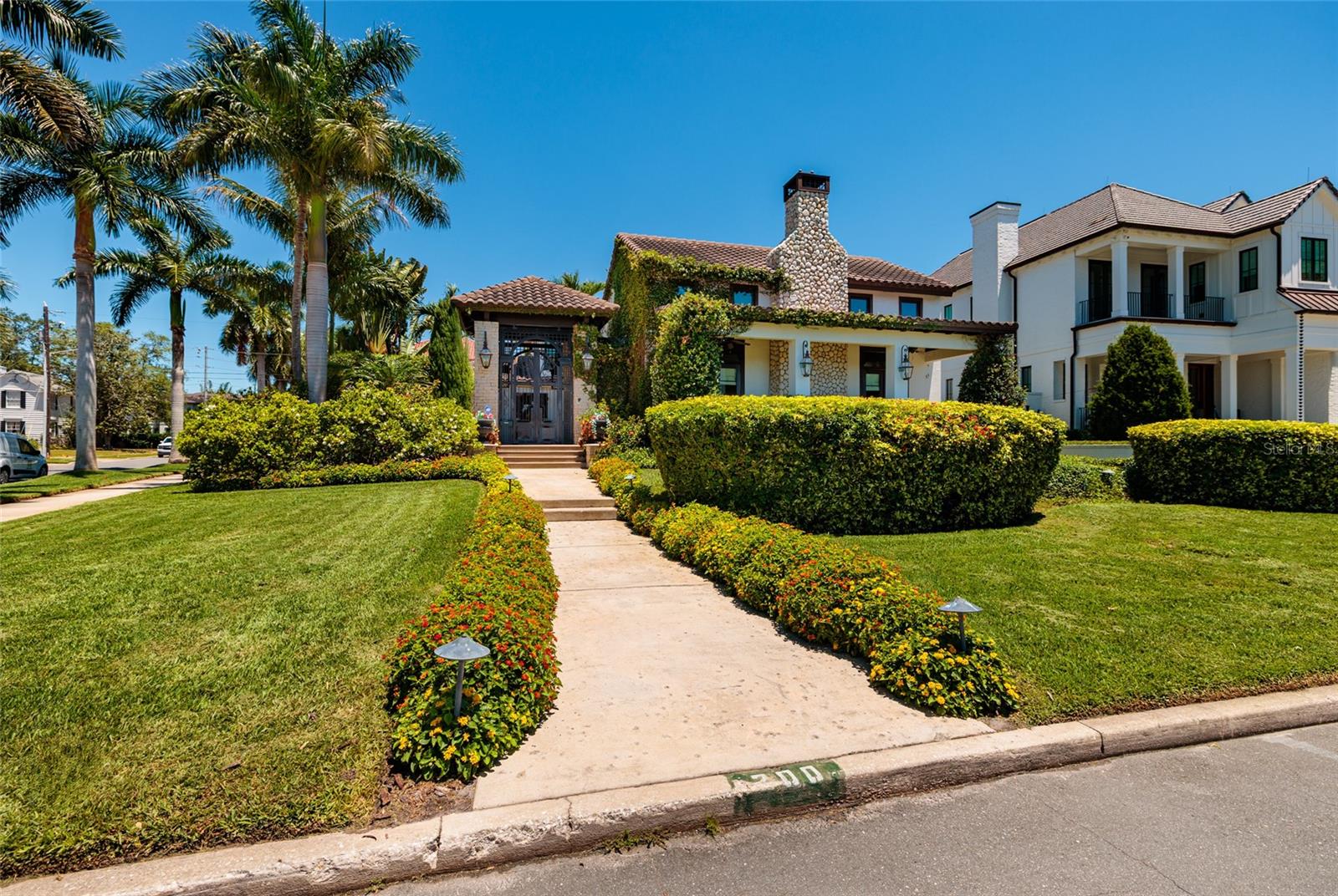Experience Unmatched Luxury at 200 Brightwaters Boulevard NE, St. Petersburg, FL! Welcome to this one-of-a-kind custom-built home, artfully crafted by its original owner to offer the pinnacle of luxury living in the heart of one of St. Petersburg's most desirable waterfront neighborhoods, Snell Isle! Combining timeless design with modern elegance, this LEED Certified Silver-Level home is a tranquil oasis that caters to both grand entertaining and private retreat. Upon entry, you'll be captivated by the expansive open-concept family room, adorned with a stunning wood-burning limestone fireplace and impressive architectural joist beams. Intricate custom millwork flows throughout the home, adding an air of sophistication. French doors flanking the fireplace open to a spacious front porch, offering sweeping views of the waterfront and downtown St. Petersburg. The heart of the home is the chef’s kitchen, where culinary dreams come to life. This space is anchored by a 12-foot island and features top-of-the-line appliances, including a handmade Italian ILVE commercial-grade stove, a new Subzero refrigerator, and a Wolf warming drawer. The adjacent butler's pantry provides ample storage and an additional refrigerator, perfect for catering and large gatherings. Step outside to your private outdoor paradise, designed for exceptional entertainment and relaxation. The saltwater self-cleaning pool, heated spa, and covered patio are complemented by a fully equipped outdoor kitchen with two grilling stations—ideal for hosting day or night. Lush landscaping ensures complete privacy, creating a serene retreat in your own backyard. The main-level owner’s suite is a haven of luxury, featuring custom millwork, a morning bar, a spacious walk-in closet with an organizer system, and a luxurious en-suite bath with a floor-to-ceiling walk-in shower. This space is perfect for relaxation and rejuvenation, offering a peaceful escape from daily life. Upstairs, the home continues to impress with a media room, bonus workout or office space, and a wet bar equipped with a sink, microwave, and refrigerator—ideal for guests or live-in help. Two additional bedrooms, each with walk-in closets and en-suite baths, provide comfort and privacy. Both bedrooms have access to the upper veranda, offering stunning views of the downtown skyline. Outdoors, the property shines with a deeded deep-water dock featuring two separate boat slips, complete with power and water hookups. Whether you're an avid boater or just enjoy the tranquility of waterfront living, this home provides easy access to the best of Florida's boating lifestyle. Recently painted and meticulously maintained, this home is move-in ready and offers a unique blend of elegance, functionality, and sustainability. Just a short walk, bike, or golf cart ride from downtown St. Petersburg, this residence is perfectly situated for enjoying the area's vibrant culture and amenities. Call today to schedule your private tour and discover the luxury that awaits at 200 Brightwaters Boulevard NE!