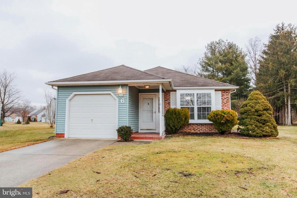 Premium court location and remodeled to make this a ready move in home. This Cambridge model offers an open concept floor plan that brings versatility for situating your furnishings.  2 Bedrooms and 2 Full Baths. The two Living room skylights  bring loads of sunshine while facing the new sliding glass door. Arrive home to the covered front porch with tiled flooring. Once inside you will me amazed at the space of the Living room. Here too is a new Kitchen with granite counter tops and new stainless steel appliance package. The formal Dining room is ready for your entertaining. Luxury vinyl plank flooring flows through as you make your way to the upgraded hall full Bath and the two Bedrooms. The primary Bedroom feature it's own full Bath with separate vanity area. Park your car in the freshly painted garage with automatic opener. Enjoy all that Holiday Village has to offer with the clubhouse and pool. Active adult living just got better.