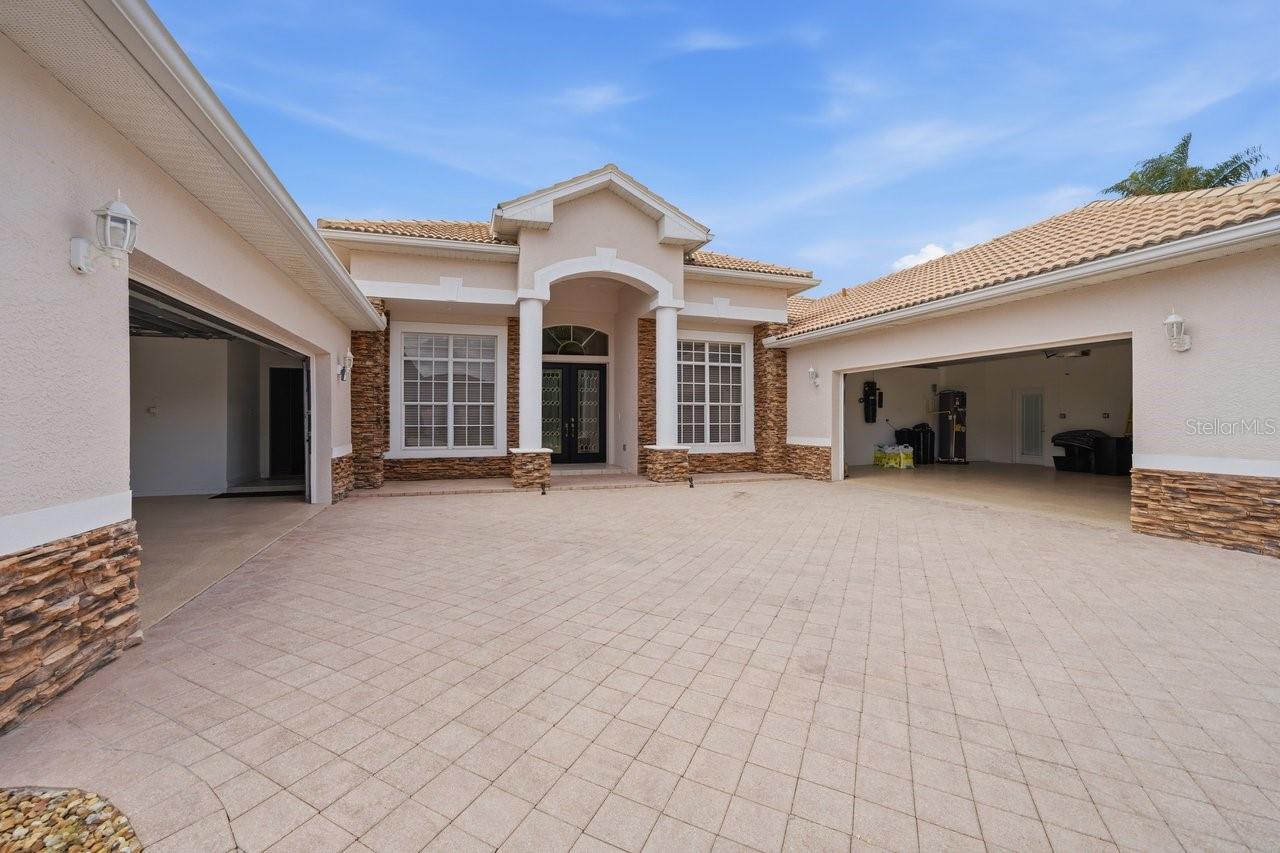 This home is both unique and stunning. A class act built and designed with quality. So If you’ve been looking for a GOLF COURSE HOME, this one right here is definitely worth a look. Sitting right on the 18TH HOLE in Silverthorn, this 5 BEDROOM, 4 BATH home gives you BEAUTIFUL SUNSET AND WATER VIEWS straight over your PRIVATE HEATED GUNNITE POOL & SPA, about as peaceful as it gets. Pulling up, you’ll notice the TWO OVERSIZED ATTACHED GARAGES,  each with a WALK-UP FLOORED ATTIC and one has an EV CHARGING STATION,. the big PAVER DRIVEWAY has plenty of room for parking when friends and family come by. Inside, you’ve got, TRAVERTINE stone, CHERRY AND OAK WOOD FLOORS, all no wax, ez clean and a standout STONE, GAS, DOUBLE-SIDED FIREPLACE that really makes the living space feel like home. The layout is a true SPLIT FLOOR PLAN, with the PRIMARY SUITE tucked away on one side featuring TWO WALK-IN CLOSETS, with custom built in organization, a WALK-IN SHOWER, GARDEN TUB overlooking your private grotto!  On the other side, the three bedrooms have NEW CARPET, CUSTOM CLOSET ORGANIZERS, and a setup that works great for family or visitors with both shared and private bathrooms. The kitchen gives you plenty of CABINET SPACE and more than enough granite COUNTERTOP ROOM, plus an ISLAND that makes everyday living or entertaining easy. TRIPLE SLIDING GLASS DOORS open up to a SCREENED PAVER PATIO where you can relax by the pool and spa, complete with a POOL SAFETY FENCE. The pool heater keeps the water warm, even in cooler months. ALSO ENJOY the spa with remote. Additional features include a second private patio off the second master bedroom, and gardenlike landscape with Exterior LED lighting.This home has WHOLE-HOUSE WATER SOFTENING AND FILTRATION SYSTEM, ENERGY-EFFICIENT HVAC, and WHOLE-HOUSE SURGE PROTECTION. New water heaters, which one has heat pump wifi.